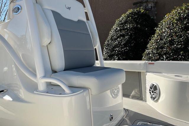 2026 Mako 24 APEX boat interior with cushioned seating and speaker system.