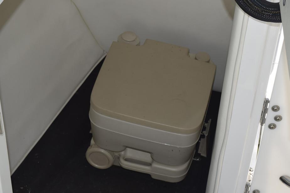 Portable toilet inside a 2006 Cobalt 240 boat cabin.
