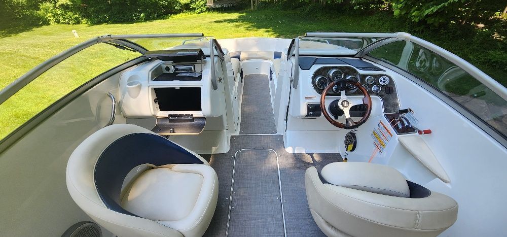 Interior of a 2007 Sea-Doo sport boat with two seats and a helm station.