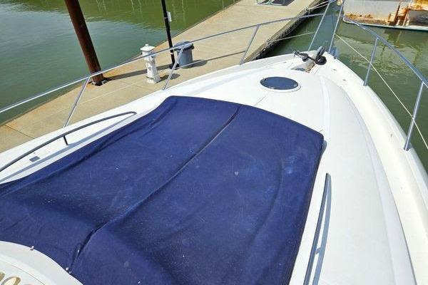 Bow view of 2005 Sunseeker Manhattan 66 yacht docked at marina.