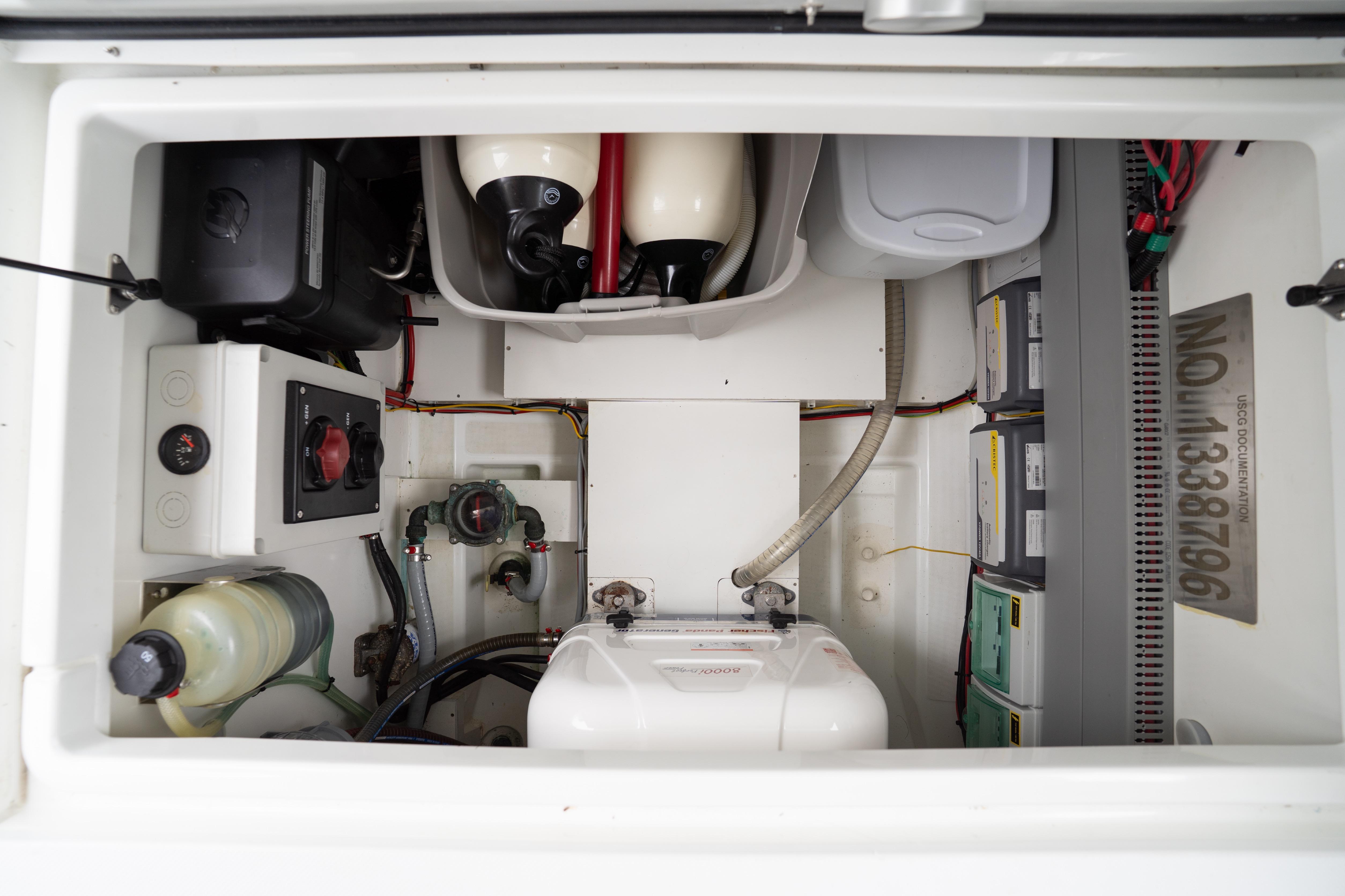 Engine compartment of 2023 Beneteau Antares 11, showcasing wiring and mechanical components.