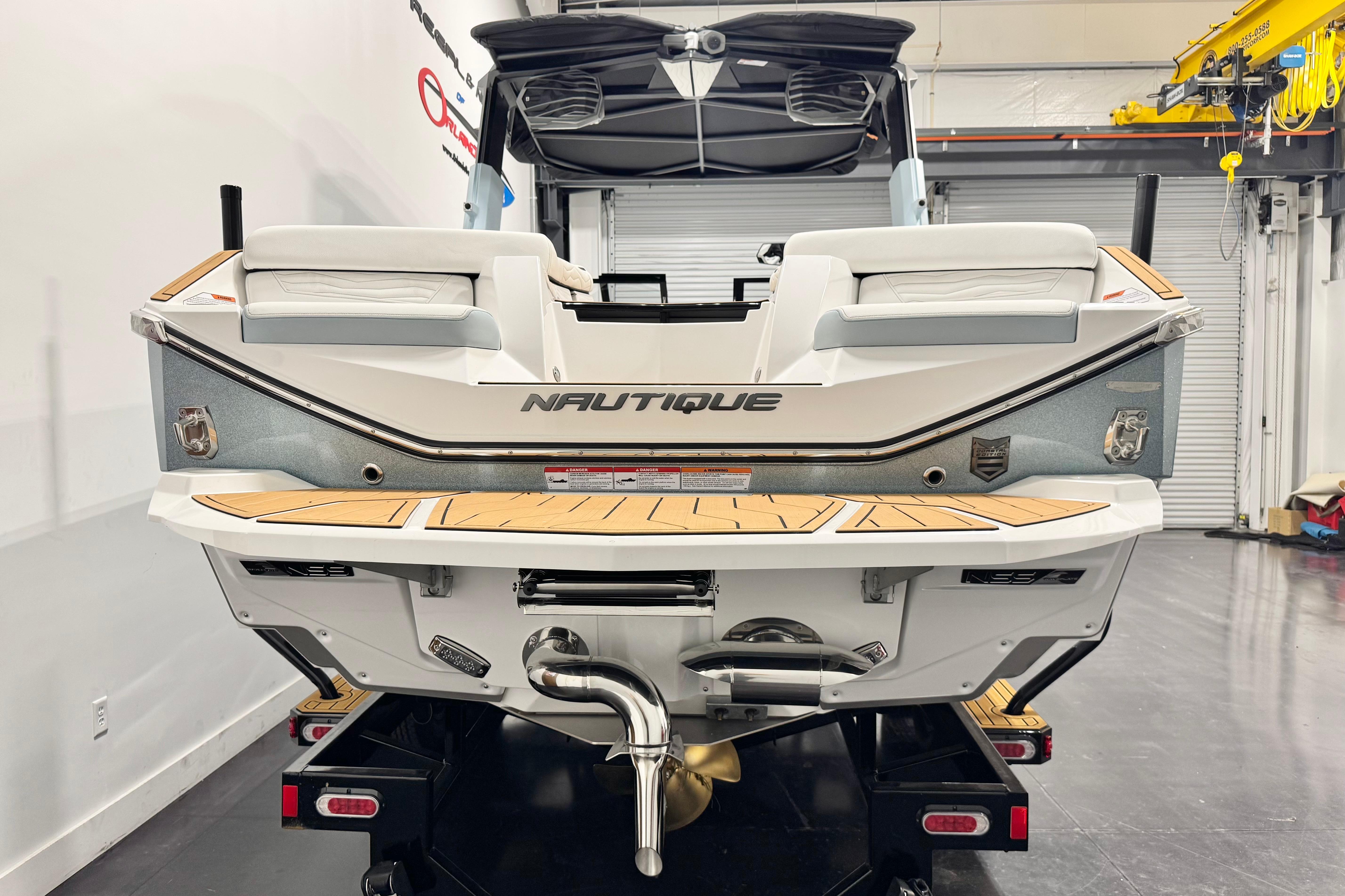 2026 Nautique Super Air Nautique G23 Paragon boat rear view in showroom.