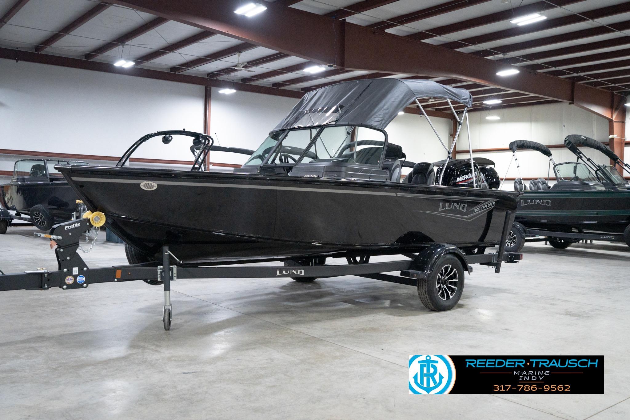 2026 Lund 1800 Explorer Sport boat in showroom, black exterior, on trailer.