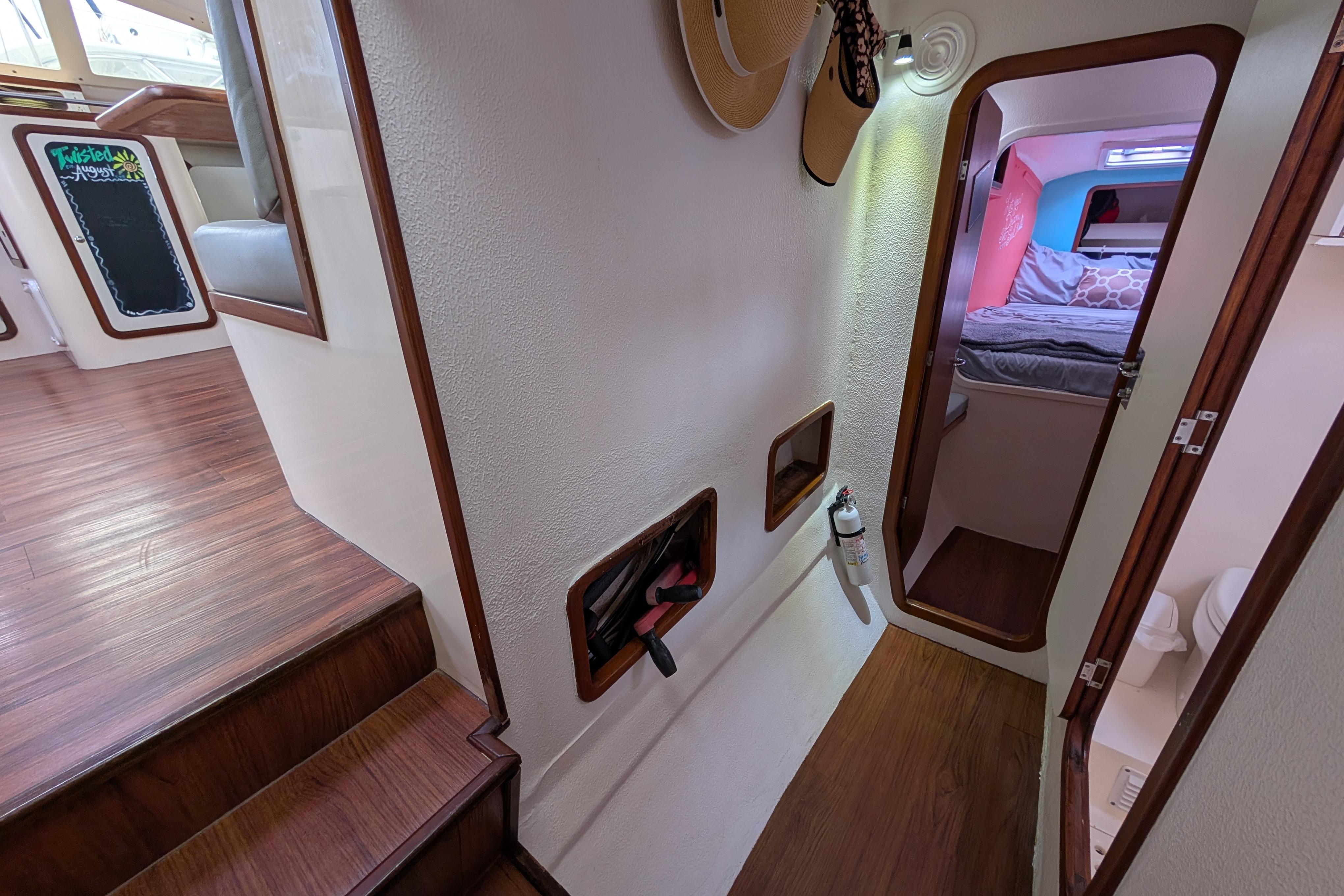 Interior of 1999 Island Spirit 37 yacht, featuring cozy cabin and wooden flooring.