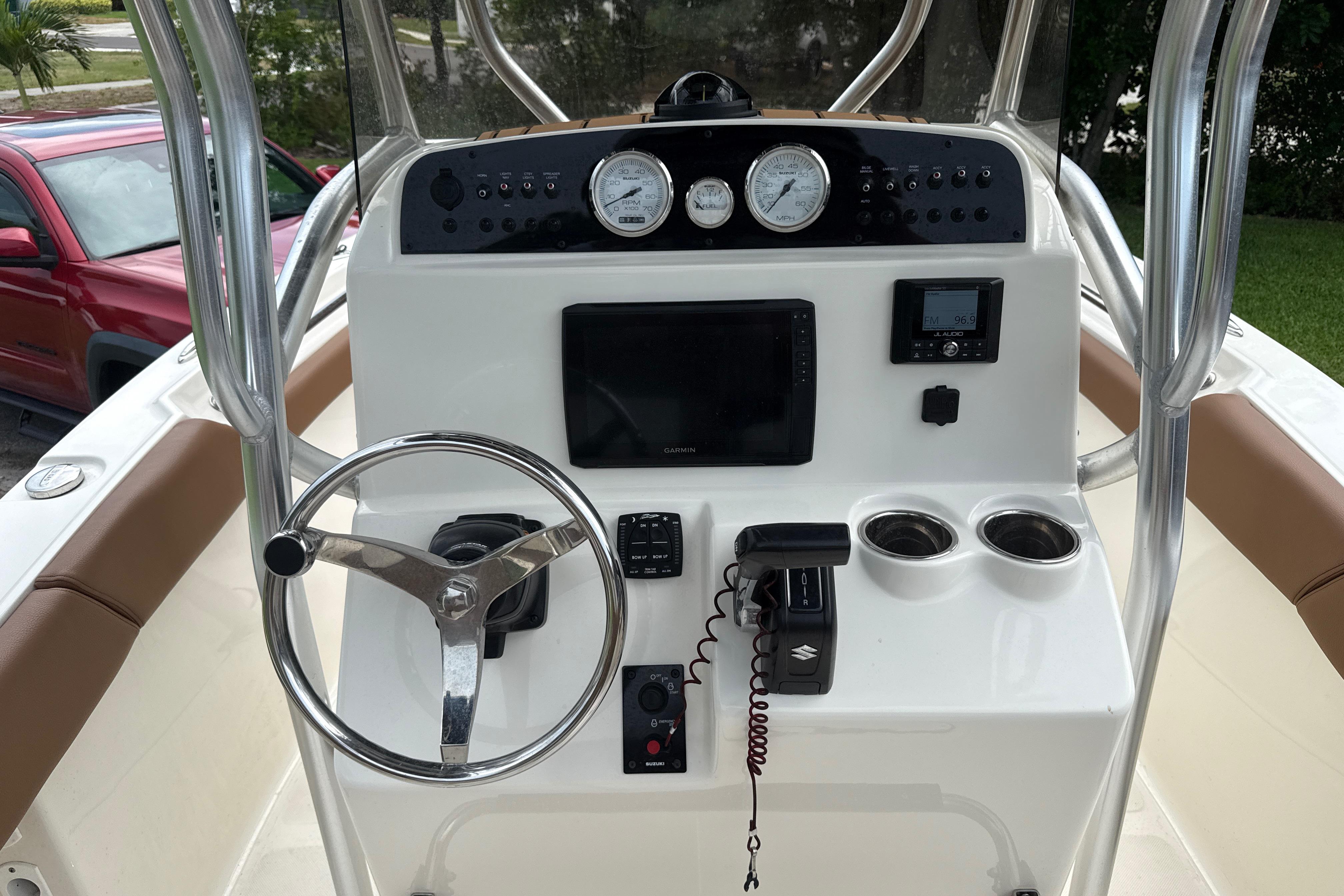 2023 Pioneer 202 Islander boat dashboard with steering wheel, gauges, and navigation controls.