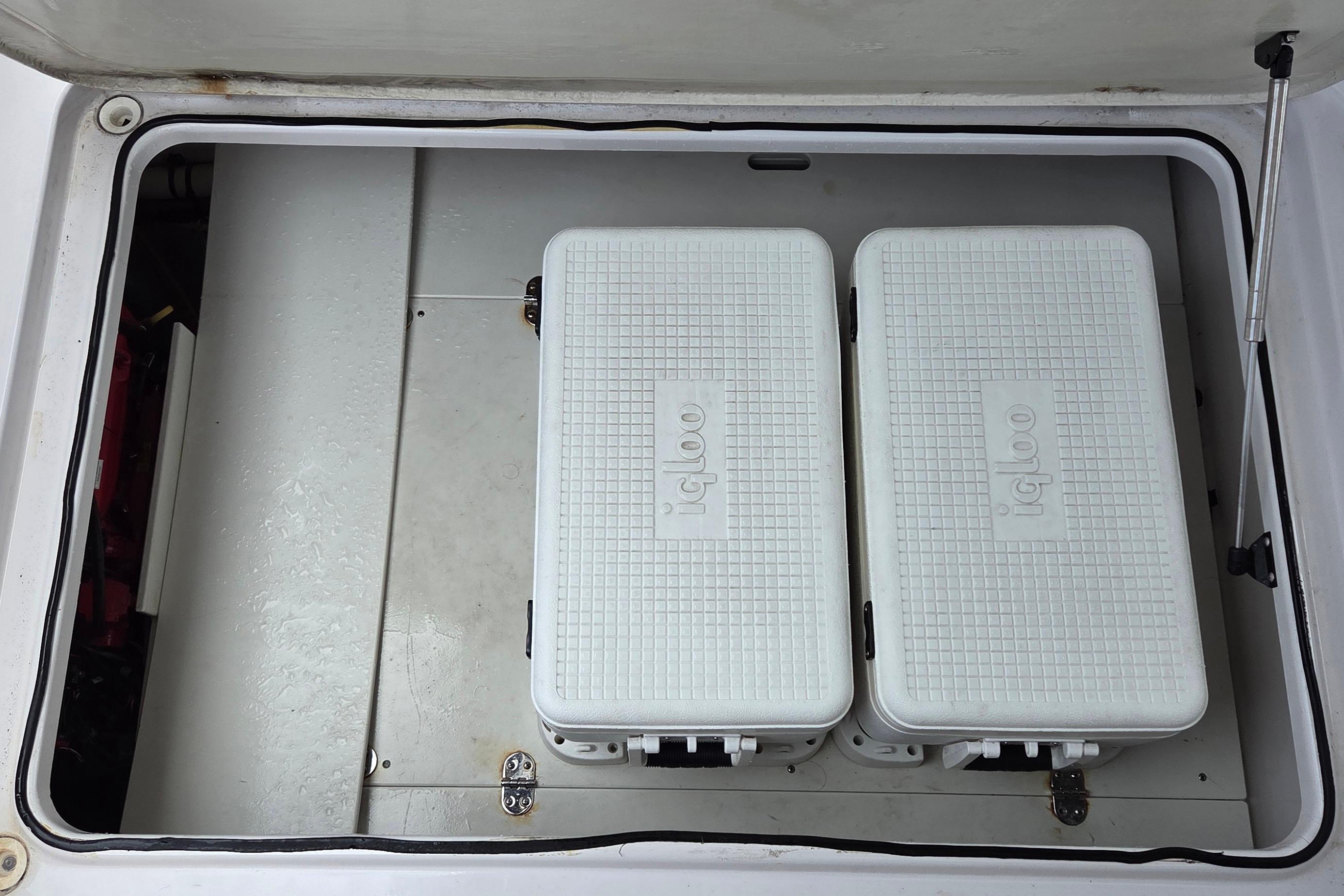 Storage compartment with two Igloo coolers on a 2019 Four Winns H350 OB boat.