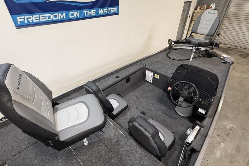 2026 Lowe Skorpion 16 boat interior with seating and steering wheel, banner reads "Freedom on the Water".