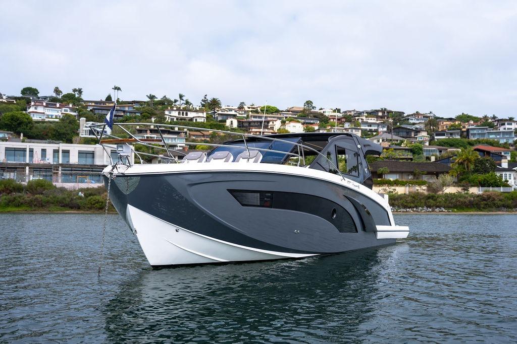 Luxury Hanover 387 yacht from 2027 on serene water, with scenic coastal backdrop.