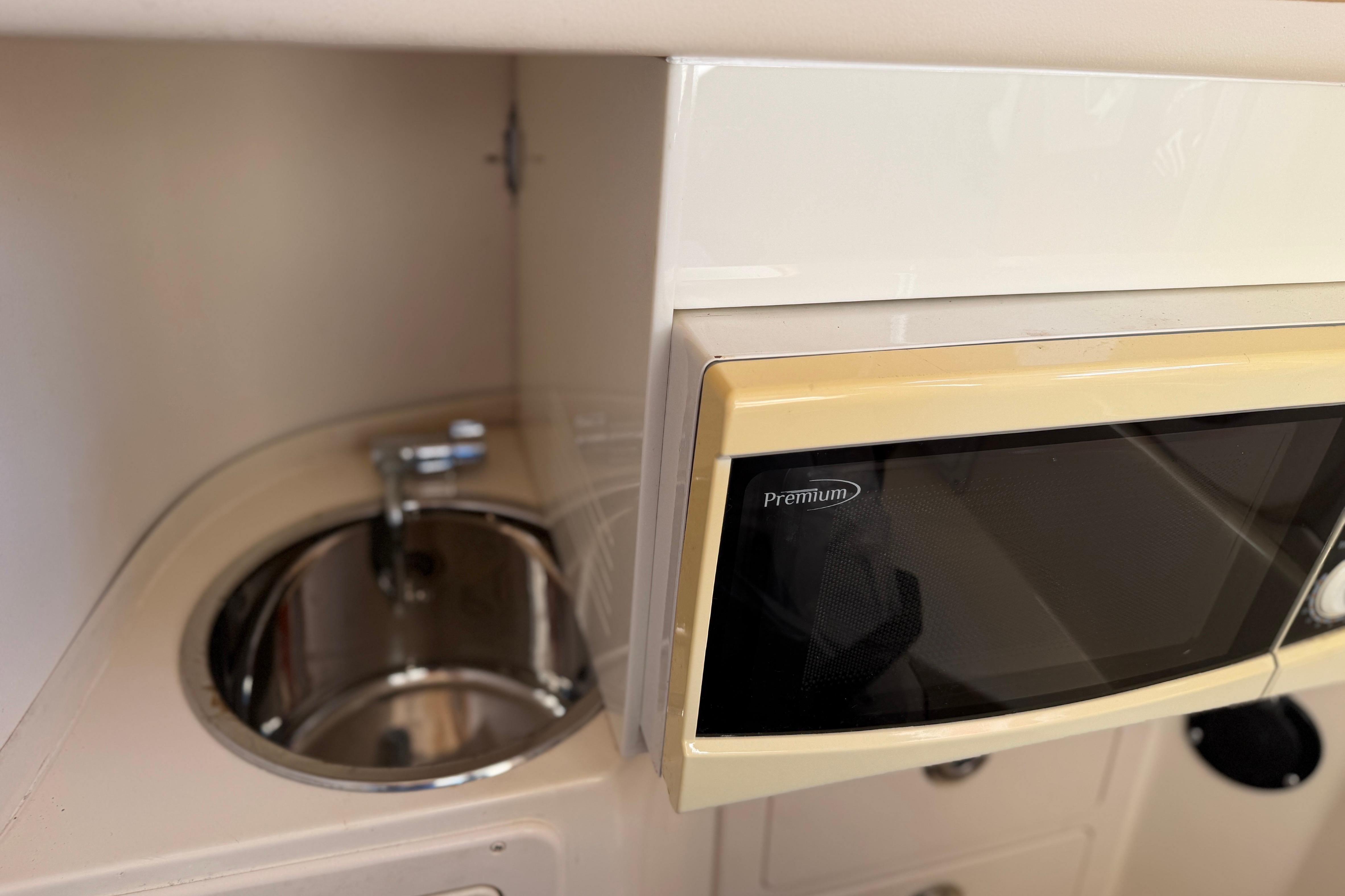 2004 Grady White 273 boat interior with sink and microwave.
