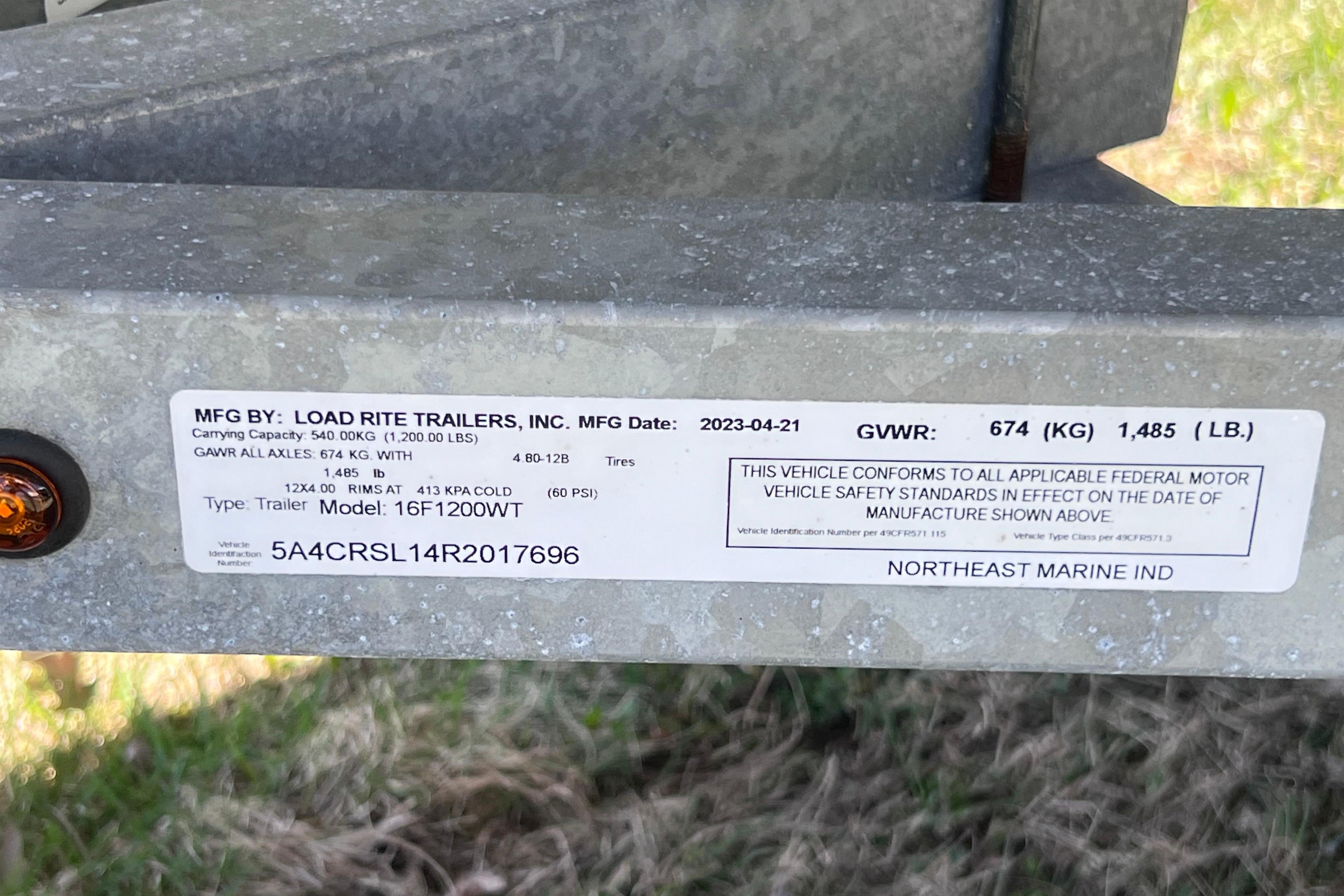 Label on Load Rite trailer, model 16F1200WT, showing specifications and compliance details.