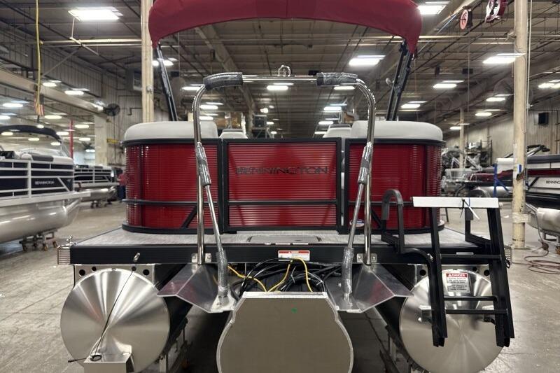 2026 Bennington 22 SSRSF pontoon boat in a showroom, rear view with red accents.