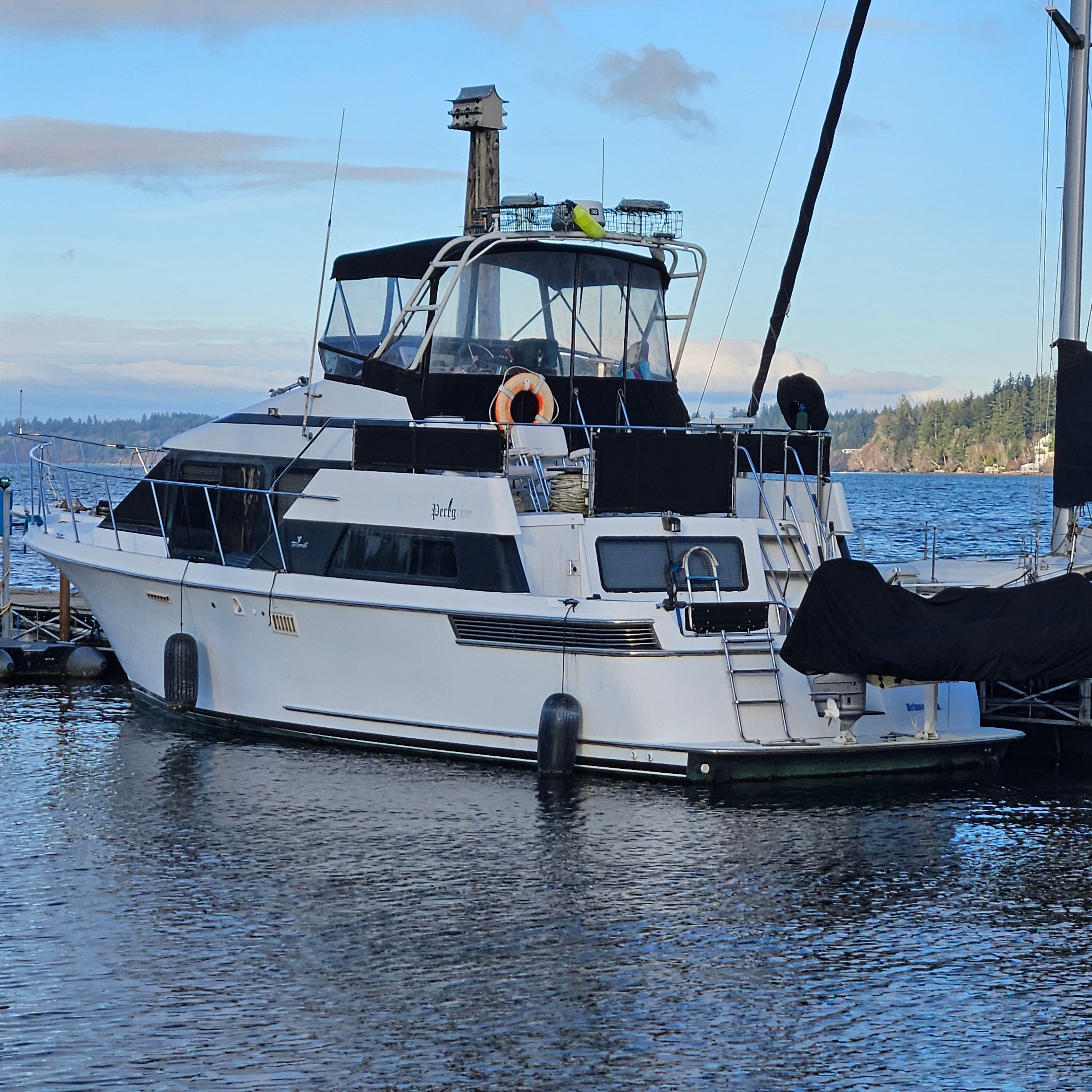 1991 Tollycraft Euro Sport Sedan yacht docked on a serene lake.