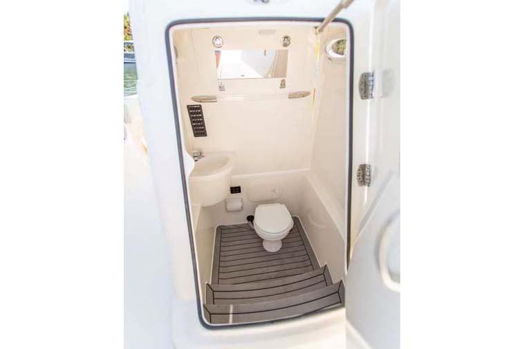 Manufacturer Provided Image: 2022 Cobia 262 Center Console boat interior bathroom with toilet and sink.
