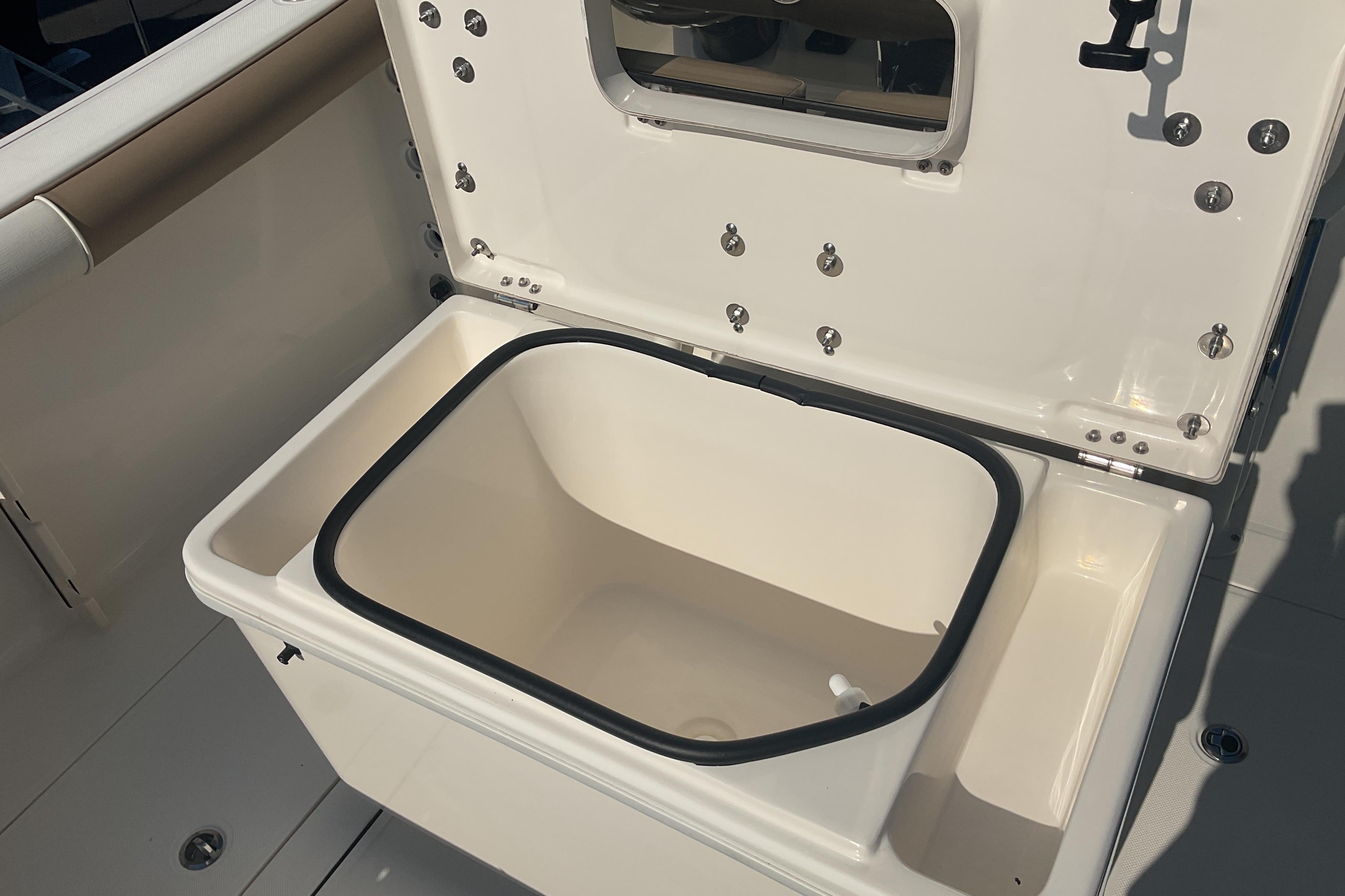 2023 Sea Born SX239 Offshore boat storage compartment open, showcasing interior space.