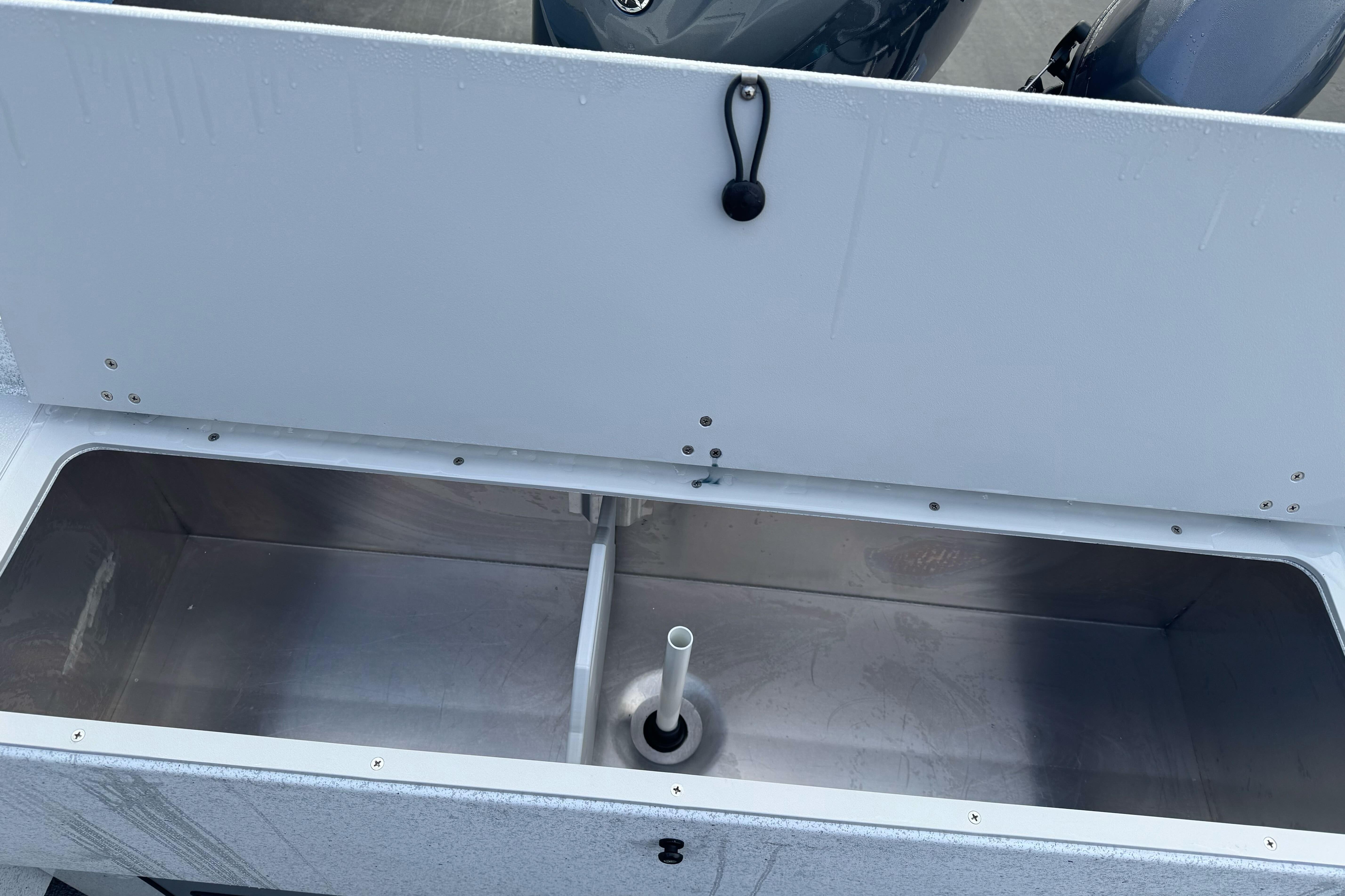Open storage compartment in KingFisher 2025 Escape boat, showcasing interior design.