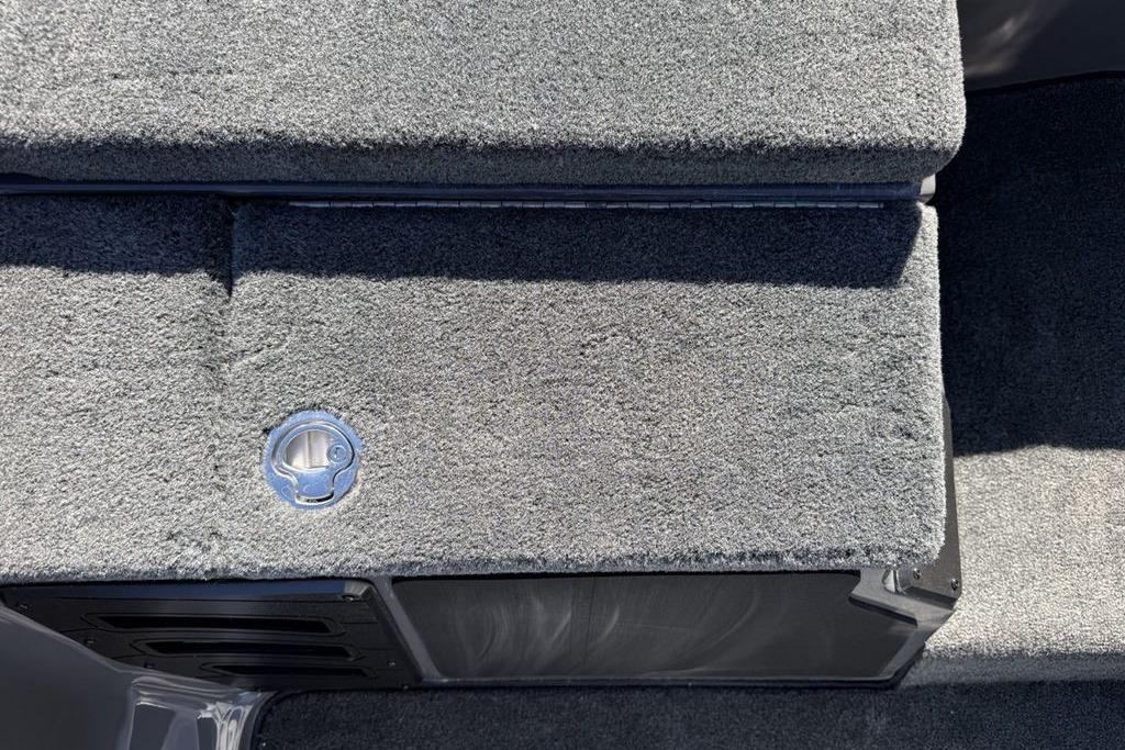 Carpeted deck of 2026 Skeeter ZX150 boat with storage compartment.