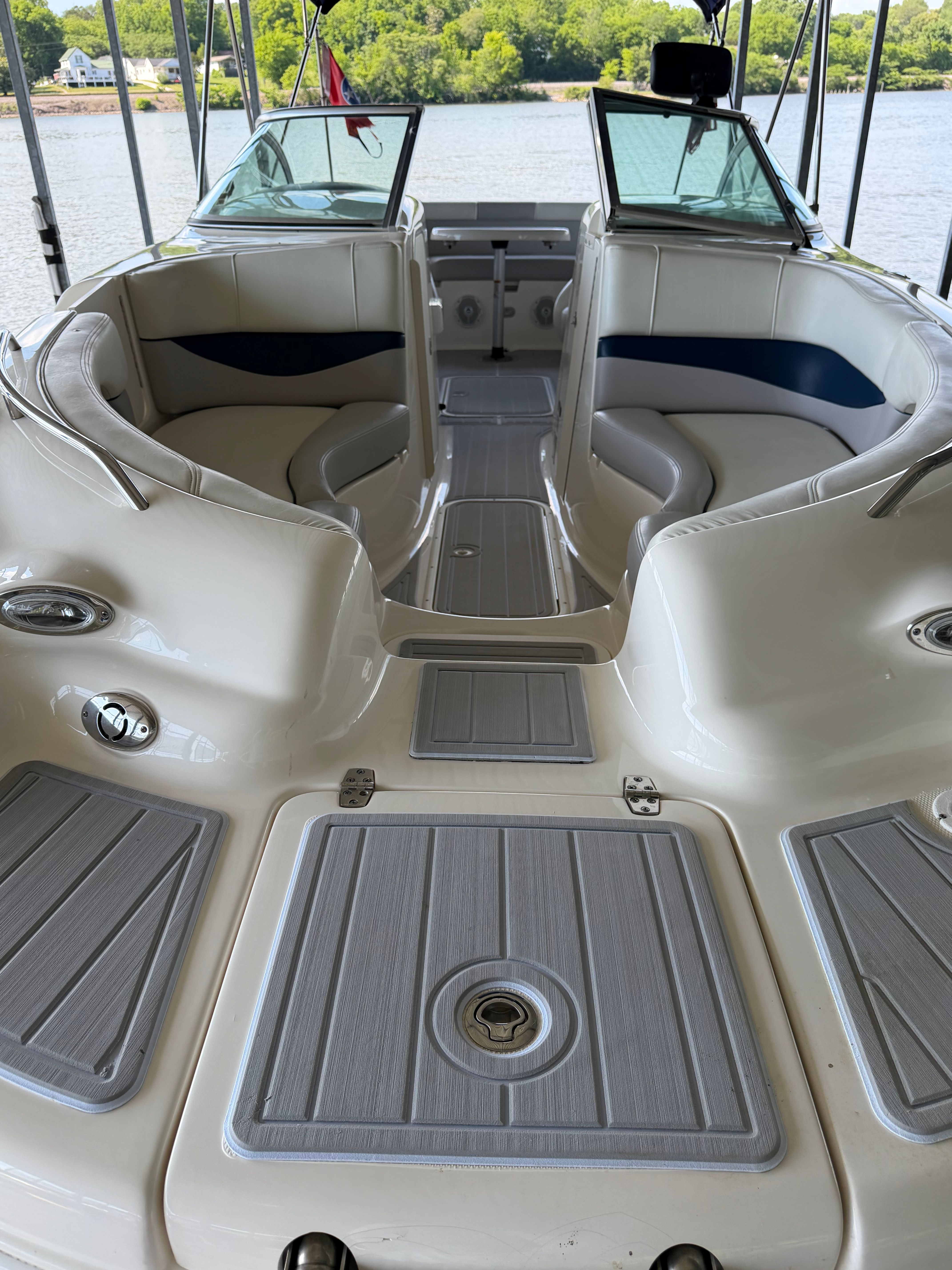 Interior view of a 2010 Bryant 255 boat on a lake.