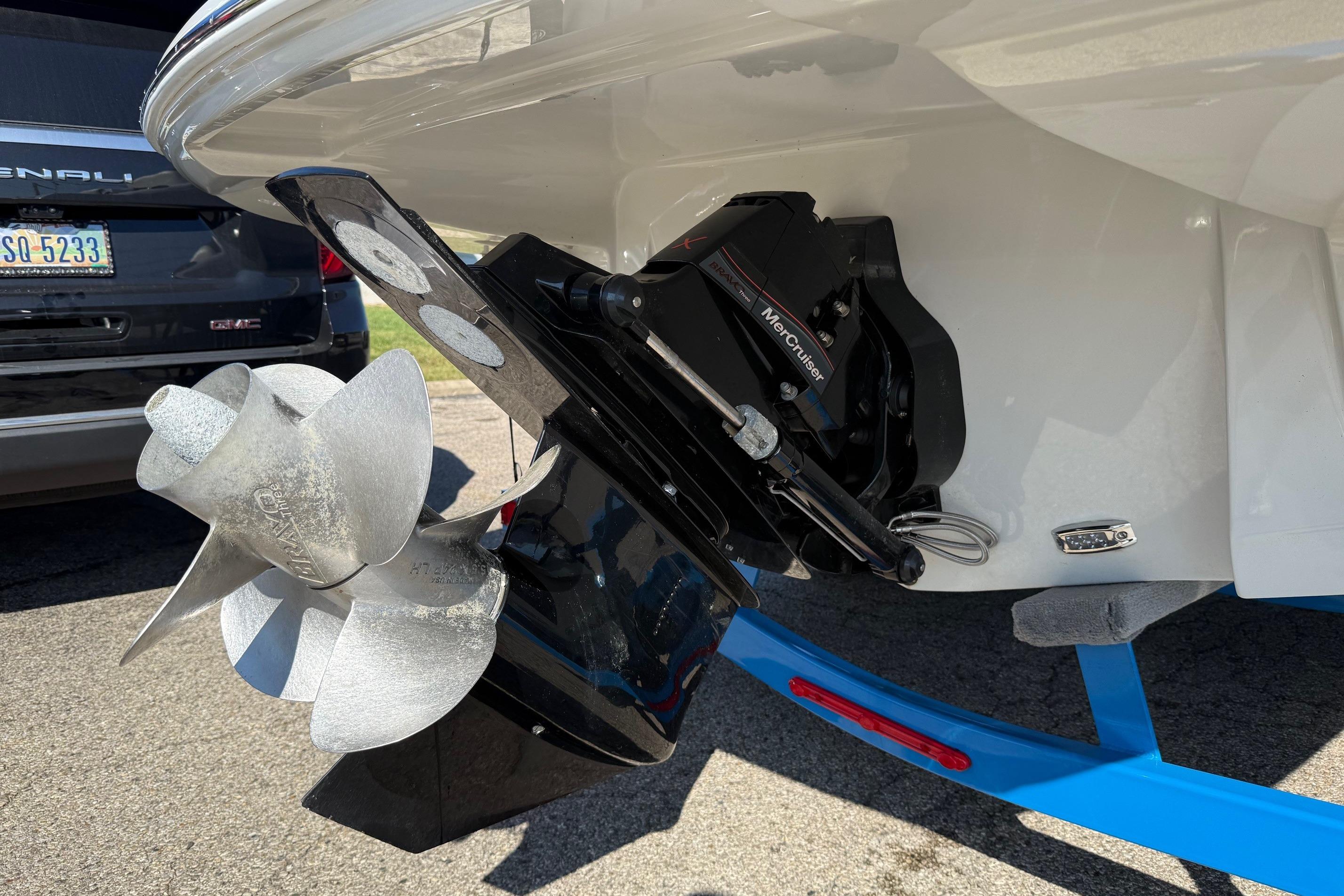 2023 Crownline 290 SS boat with MerCruiser outdrive and propeller, parked on a trailer.