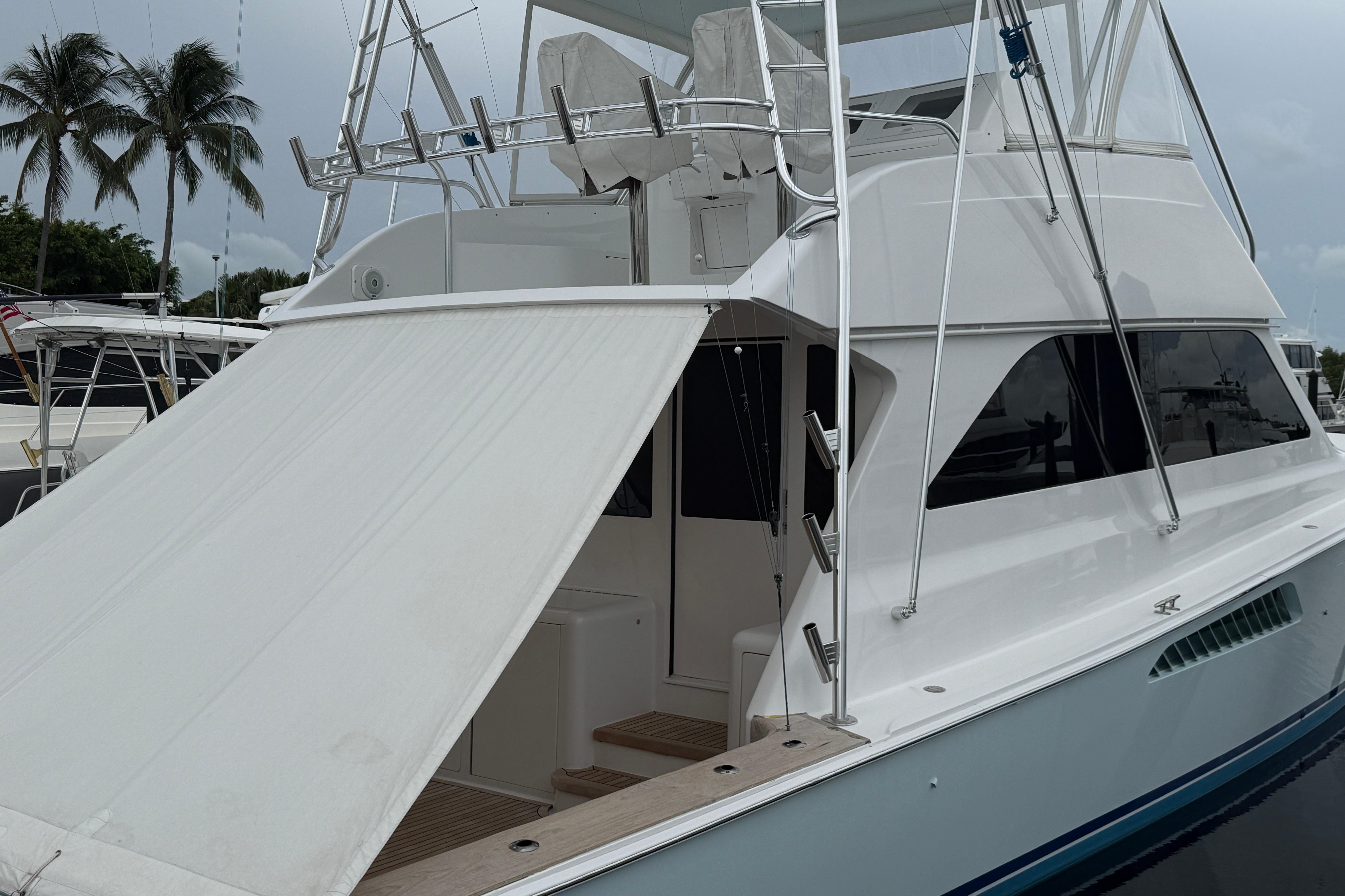 2000 Viking 55 Convertible yacht docked, featuring sleek design and spacious deck area.