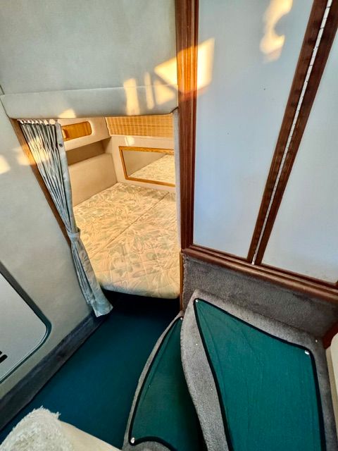 Interior of the 1992 Sea Ray 290 Sundancer featuring a cozy sleeping area.