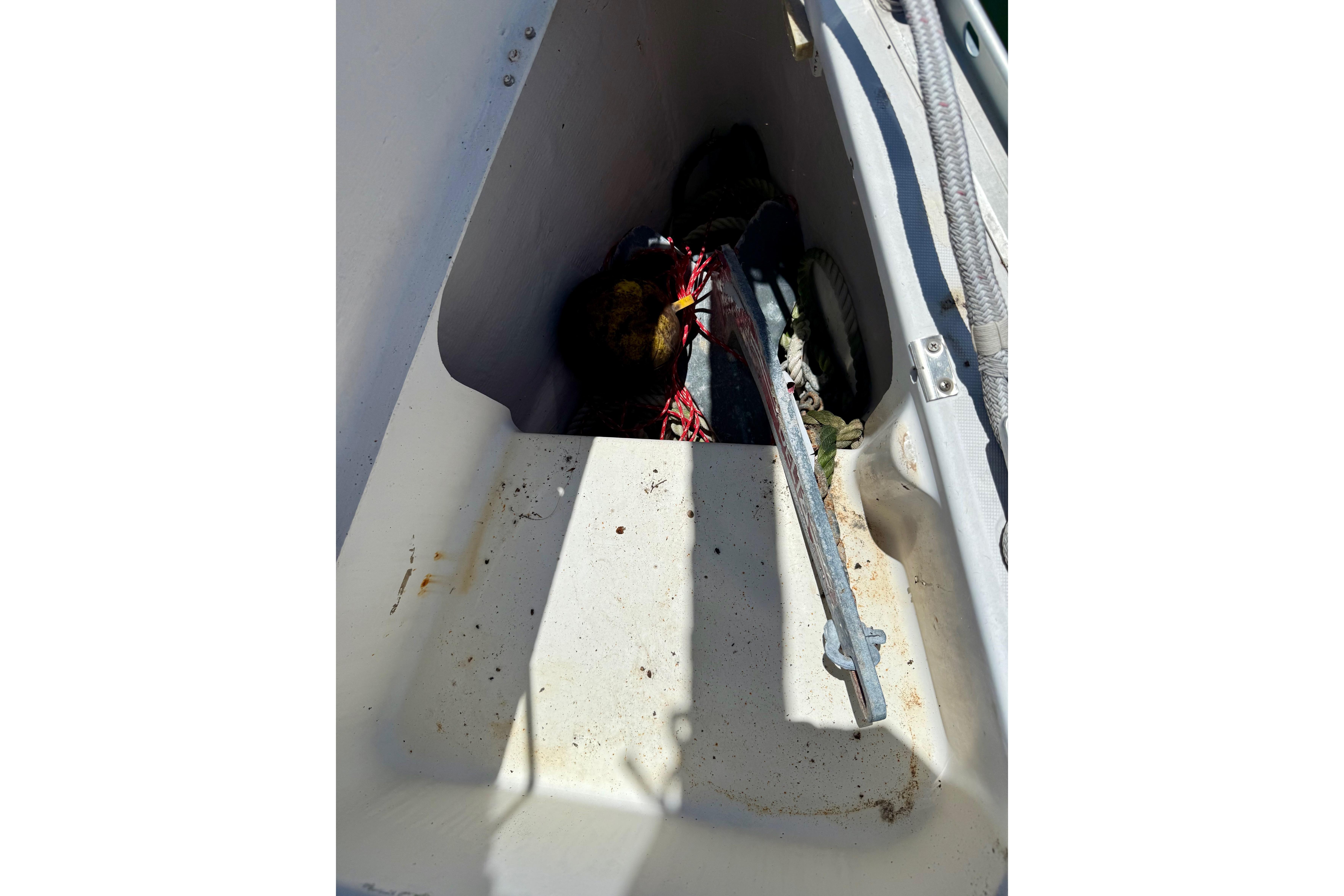 Storage compartment on a 2002 Beneteau Oceanis Clipper 311 sailboat, containing ropes and equipment.