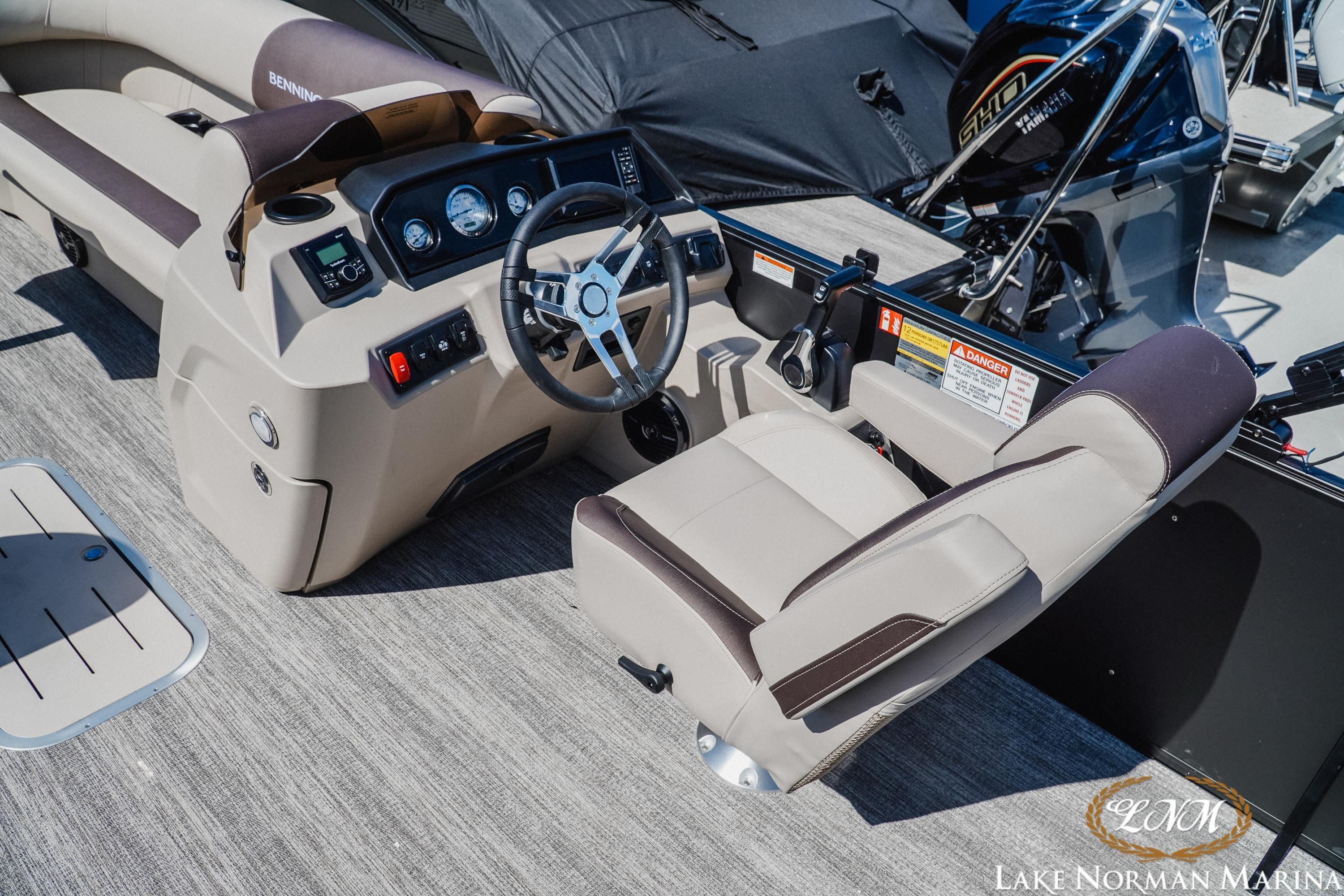 Interior view of 2027 Bennington 23ssb boat with steering console and seating.