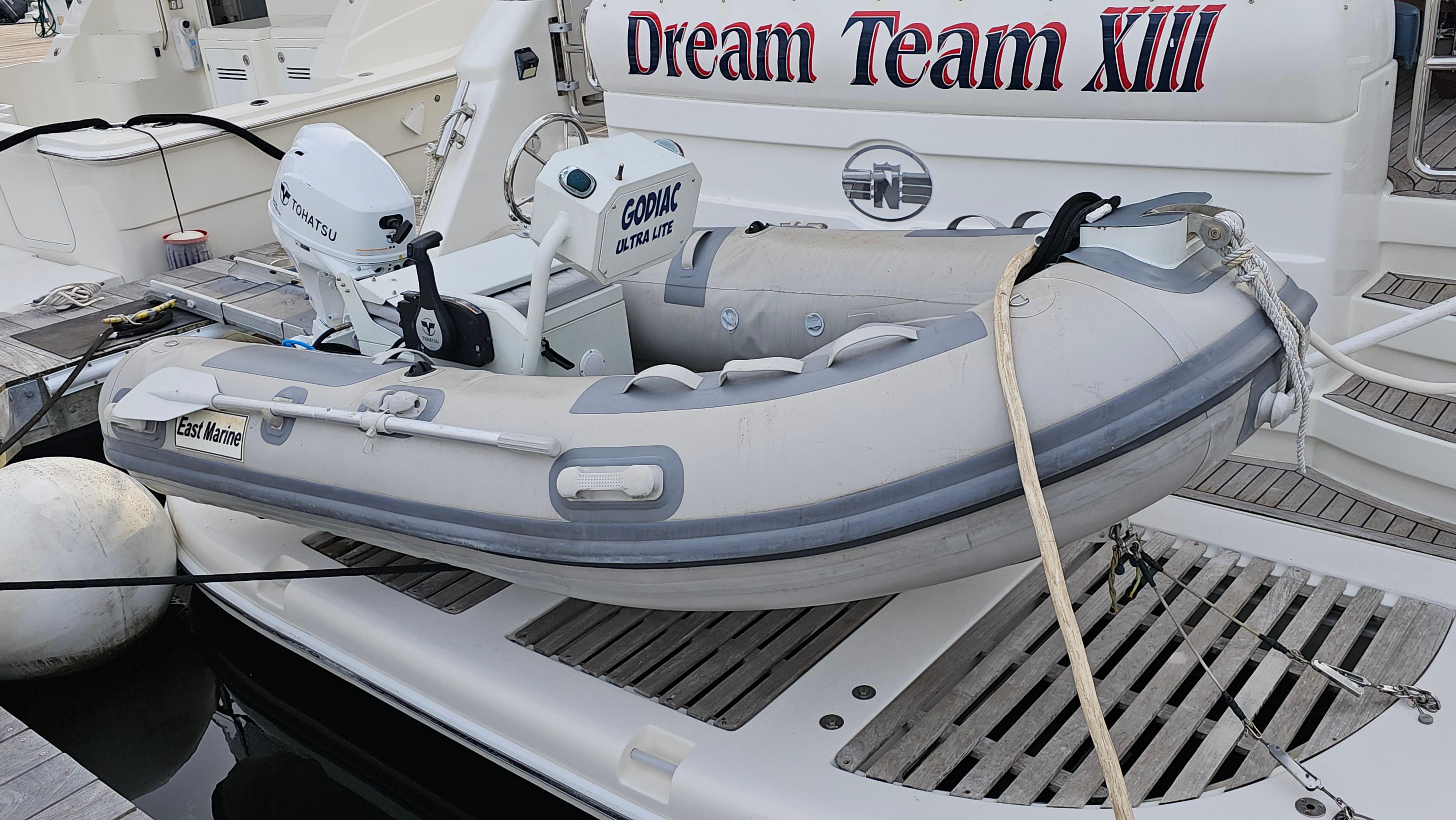 Inflatable dinghy on Neptunus 56 Flybridge yacht, 2005 model, docked with "Dream Team XIII" signage.