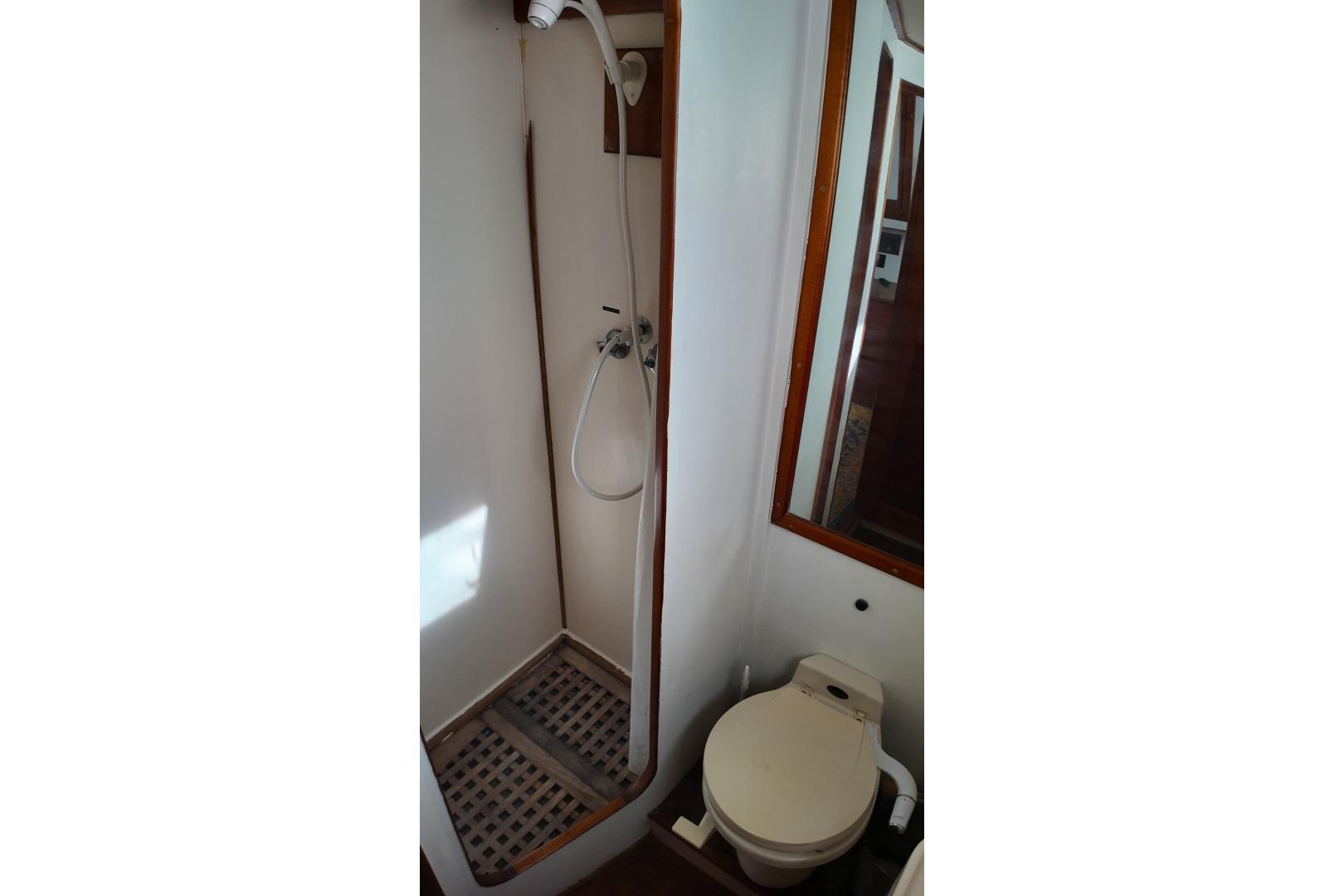 Bathroom interior of 1978 Grand Banks 42 Classic yacht, featuring shower and toilet.