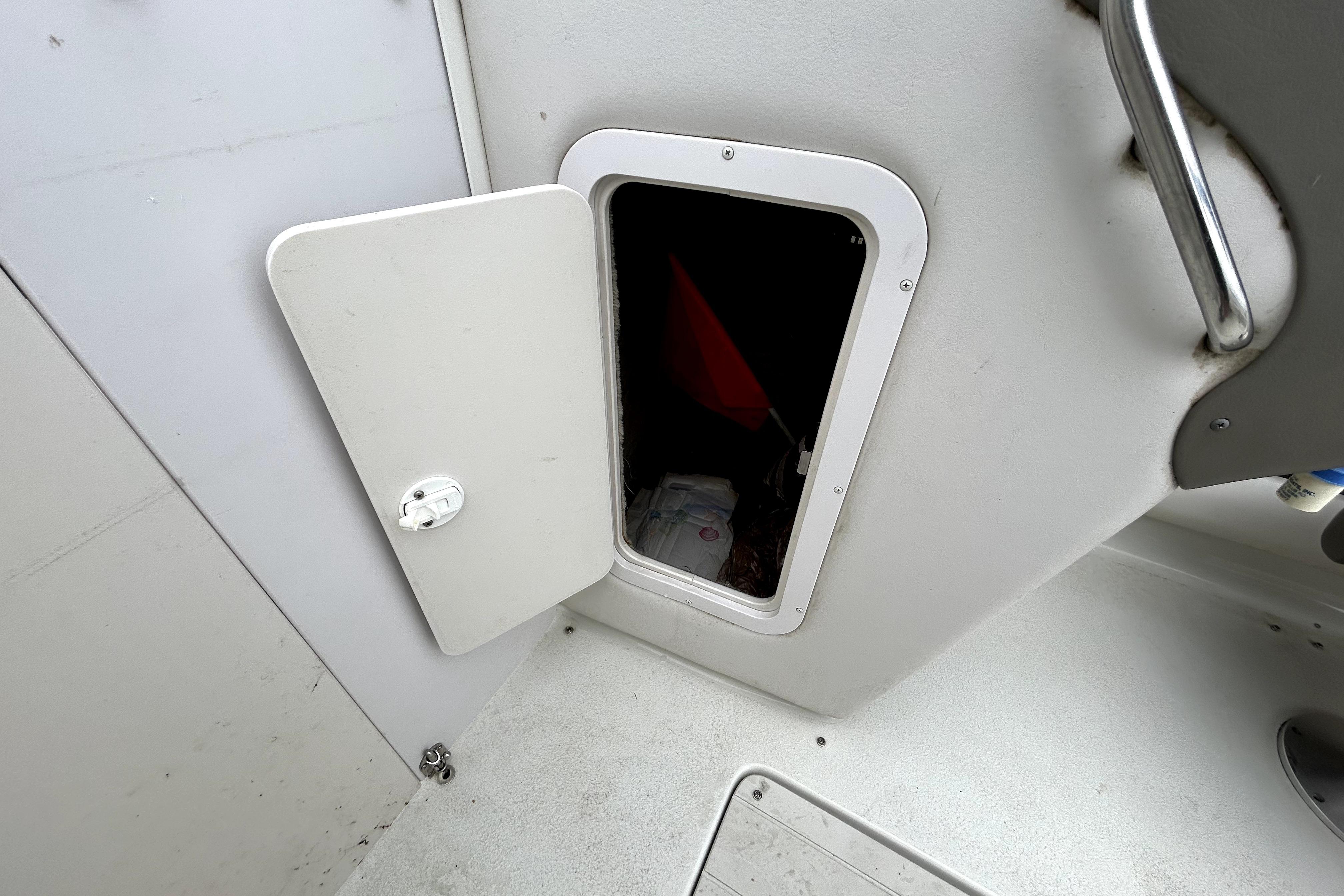 Open storage compartment on a 2001 Crownline 239 DB boat interior.