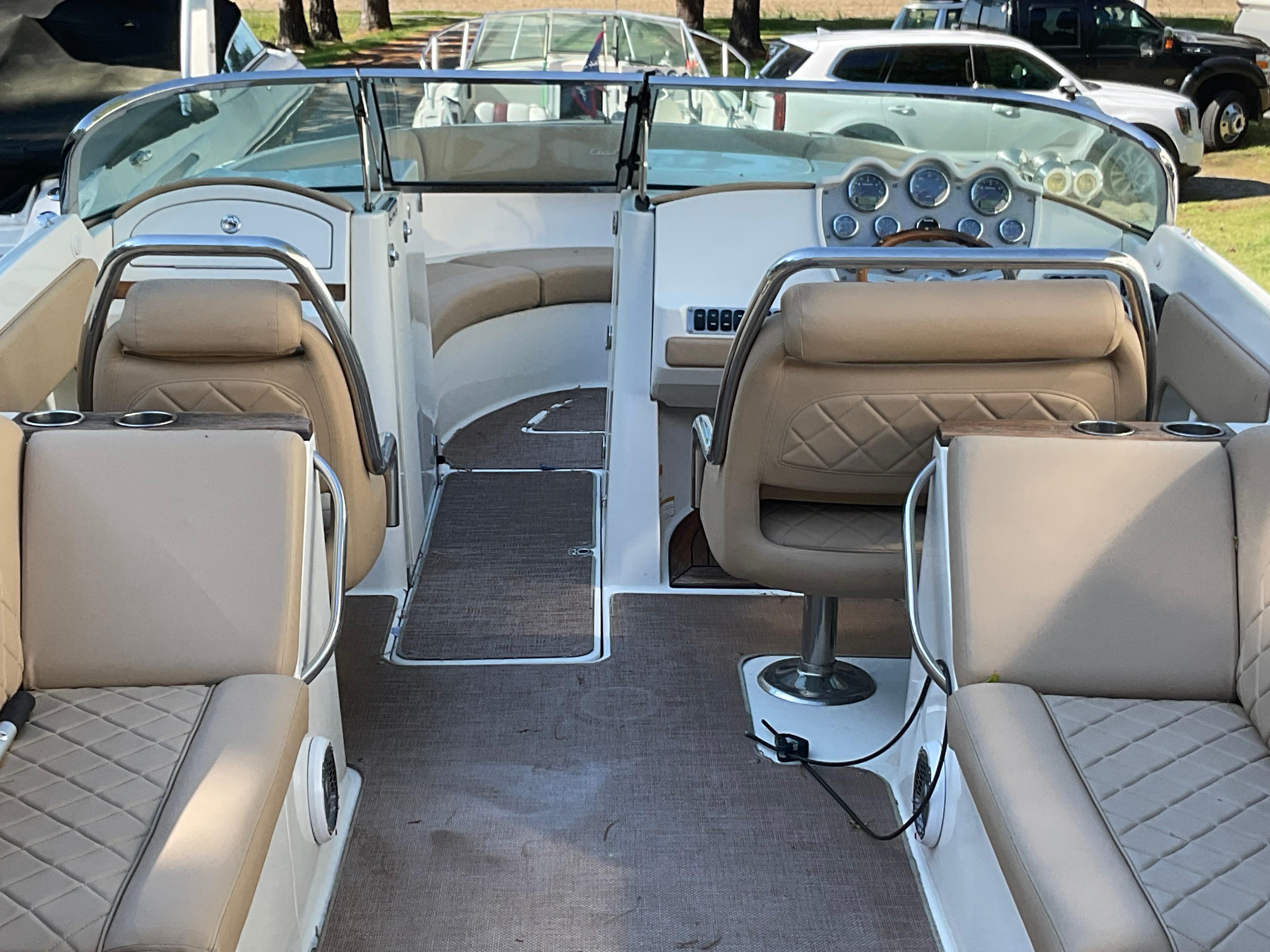 2014 Chris-Craft Launch 28 interior with beige seating and dashboard view.