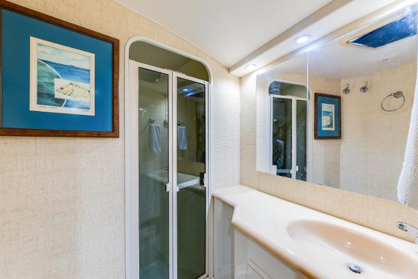 Bathroom interior of 1999 Viking 47 Convertible yacht with shower and sink.