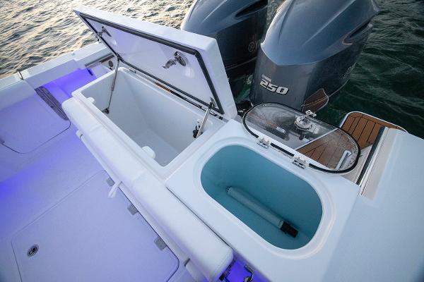 Manufacturer Provided Image: 2025 Southport 27 FE boat with open storage compartments and dual 250 engines.