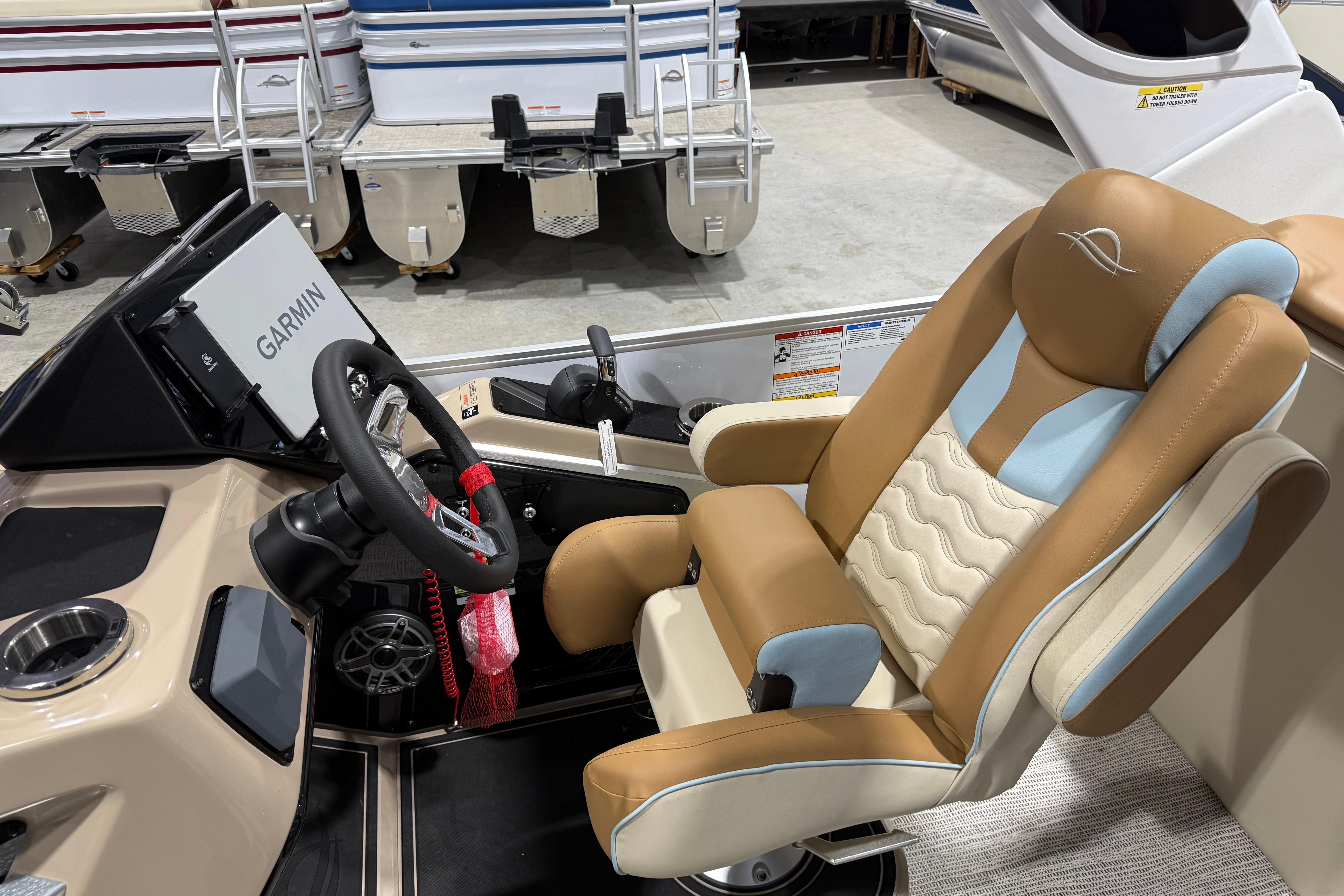 Captain's seat of 2026 SunCatcher Diamond Elite 324 RC with Garmin navigation.