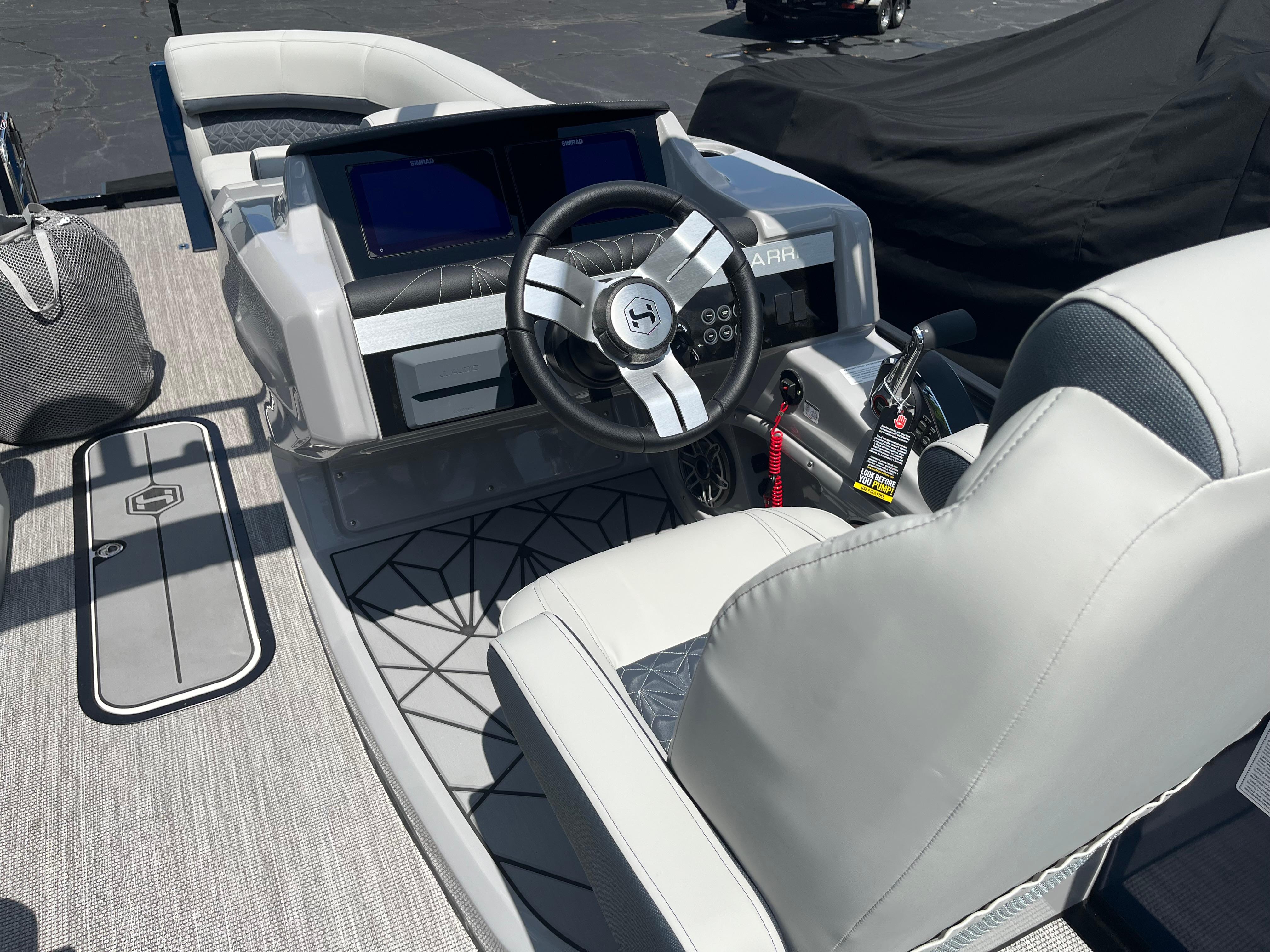 2026 Harris Grand Mariner 230 boat interior with modern dashboard and steering wheel.