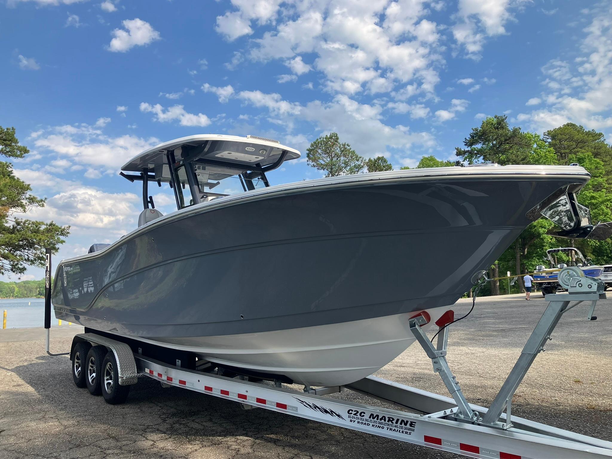 2025 Sea Fox 328 Commander boat on trailer under blue sky.