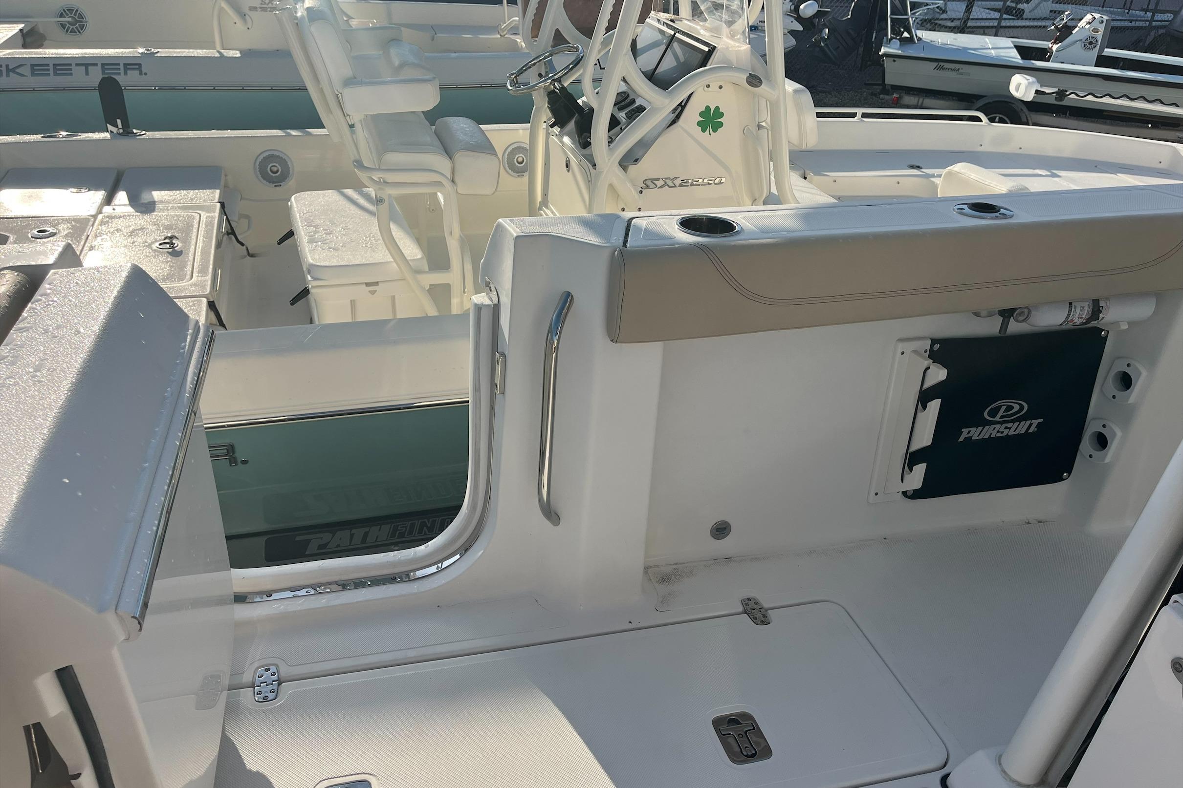 2019 Pursuit S 288 Sport boat interior with seating and steering console.