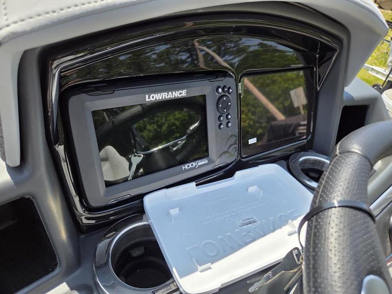 Dashboard of 2025 Regency 230 DL3 with Lowrance Hook Reveal fish finder.