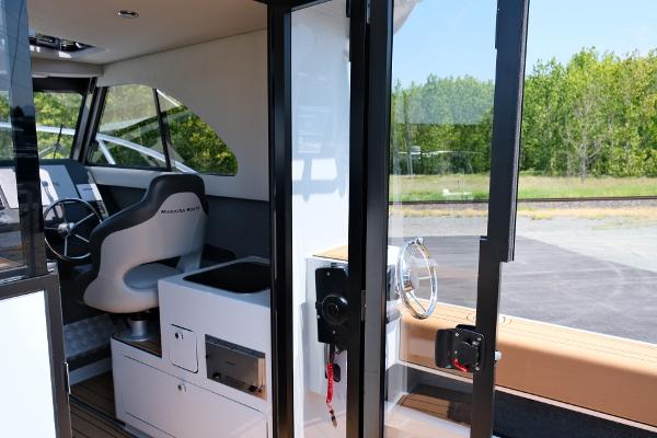 Interior view of 2023 Makaira Gen3 800 boat, featuring modern helm and seating.