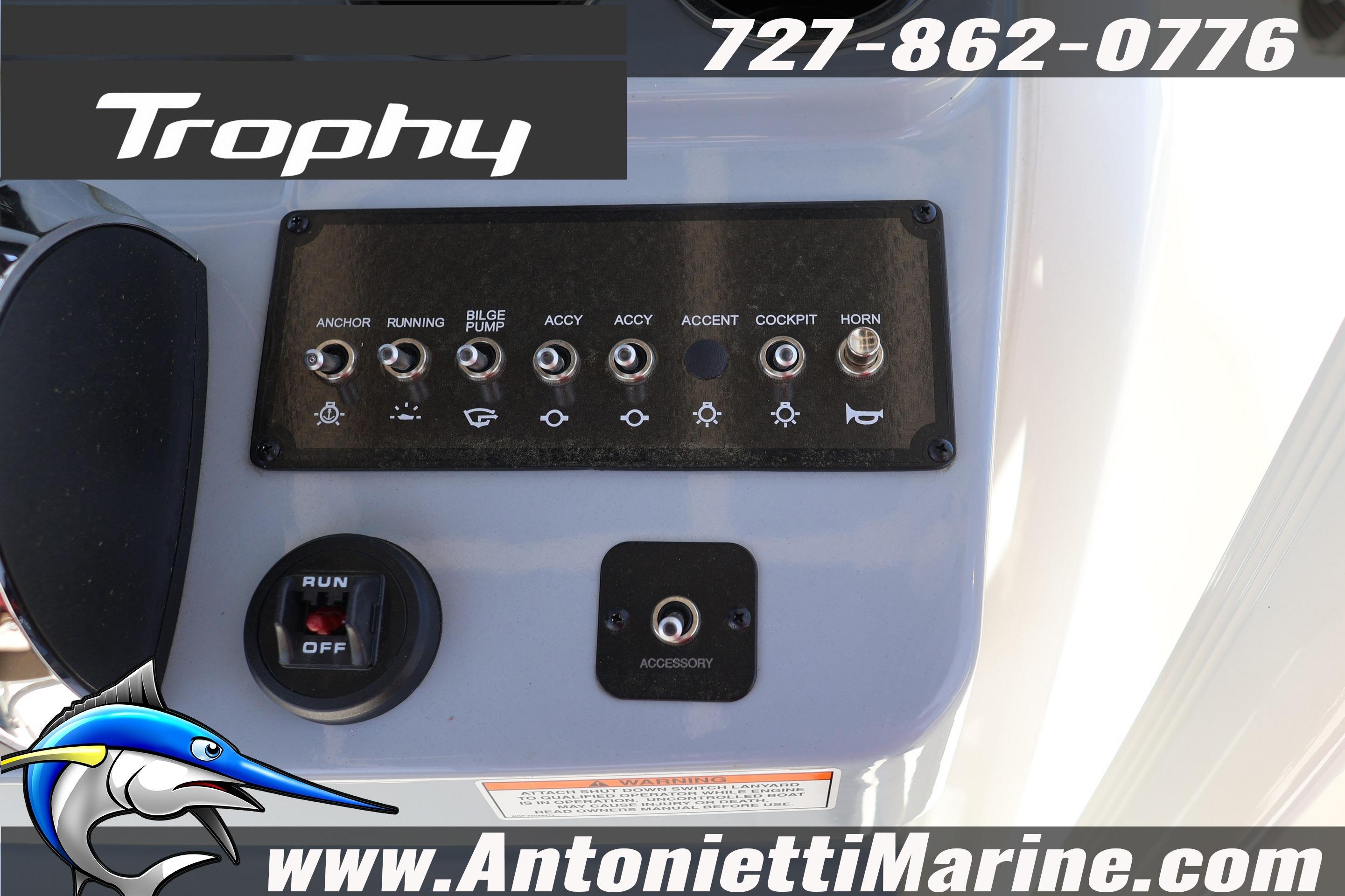 Control panel of 2026 Bayliner Trophy T20CC boat with switches and branding.