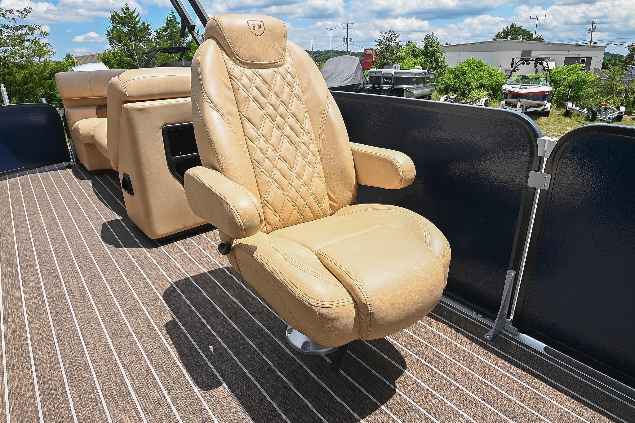 Luxurious seating on 2023 Premier 270 Intrigue RF boat, featuring tan leather upholstery.