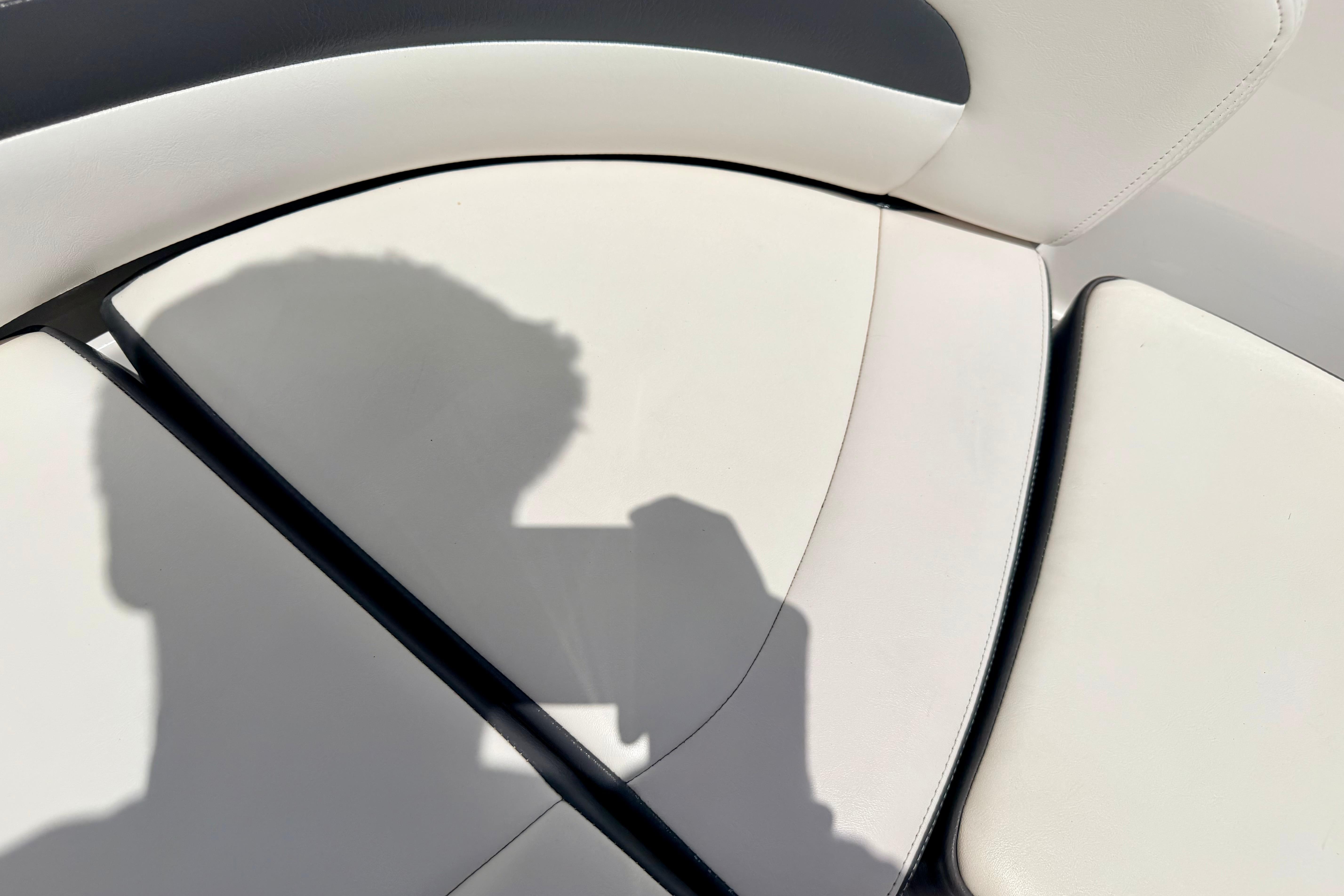 Shadow on white seating of 2015 Chaparral Sunesta 264 boat interior.