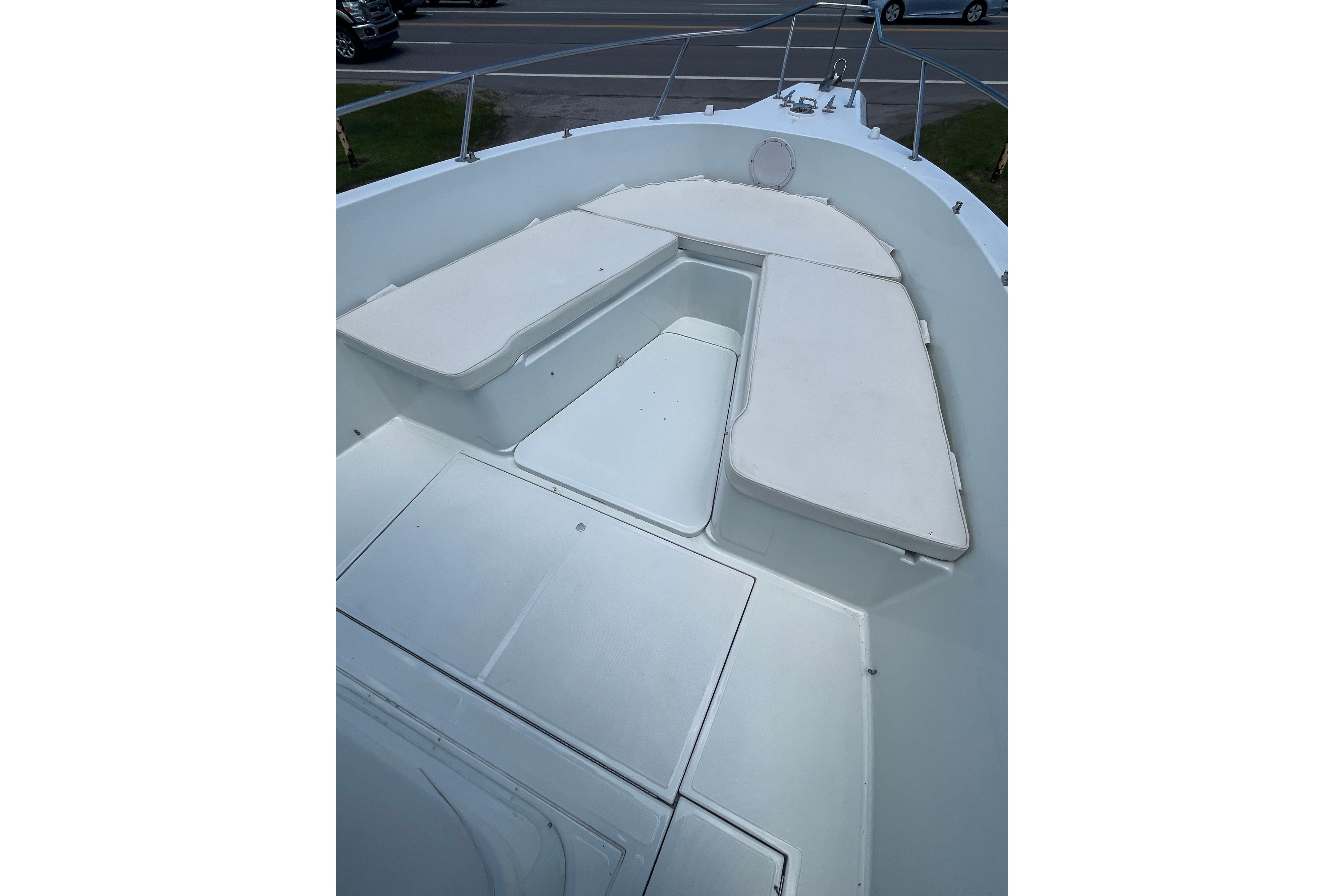 1997 Stamas boat deck with cushioned seating and storage compartments.