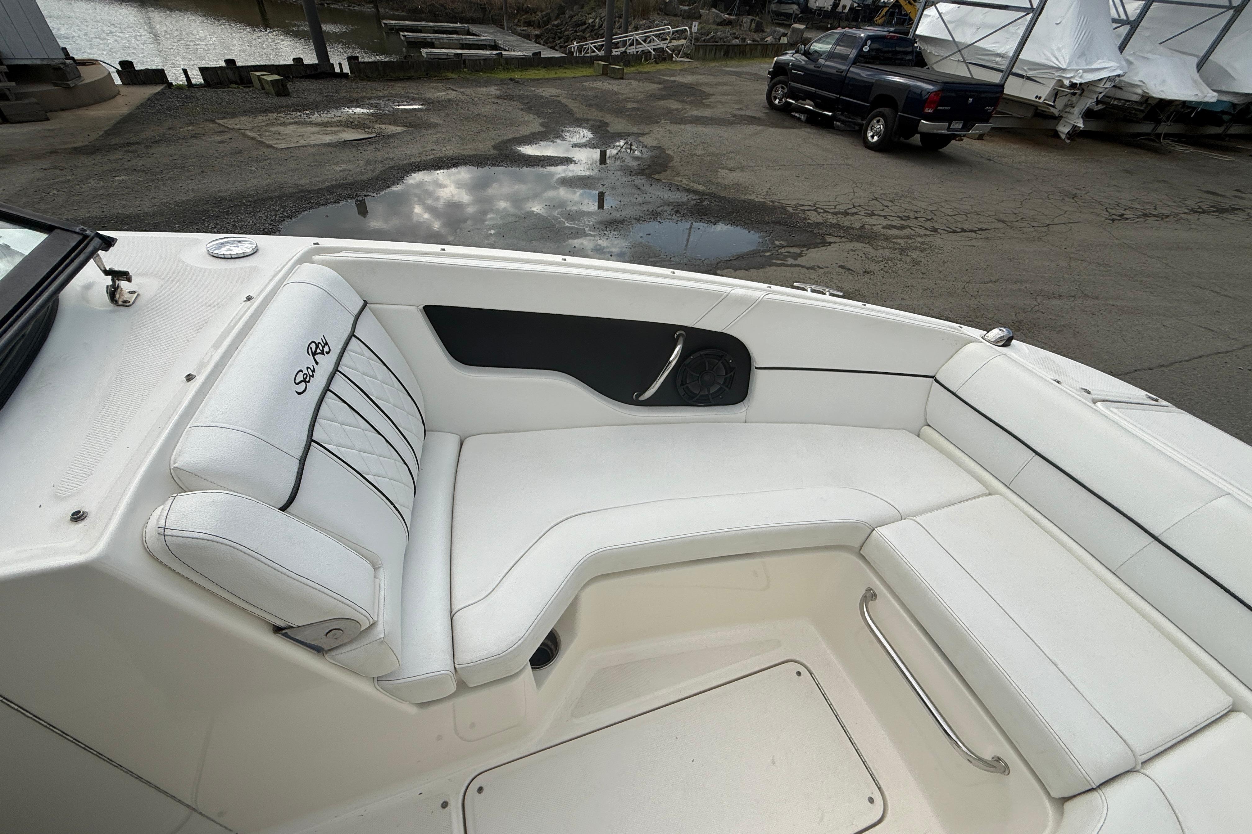 2015 Sea Ray 240 Sundeck boat interior with white seating and speaker.