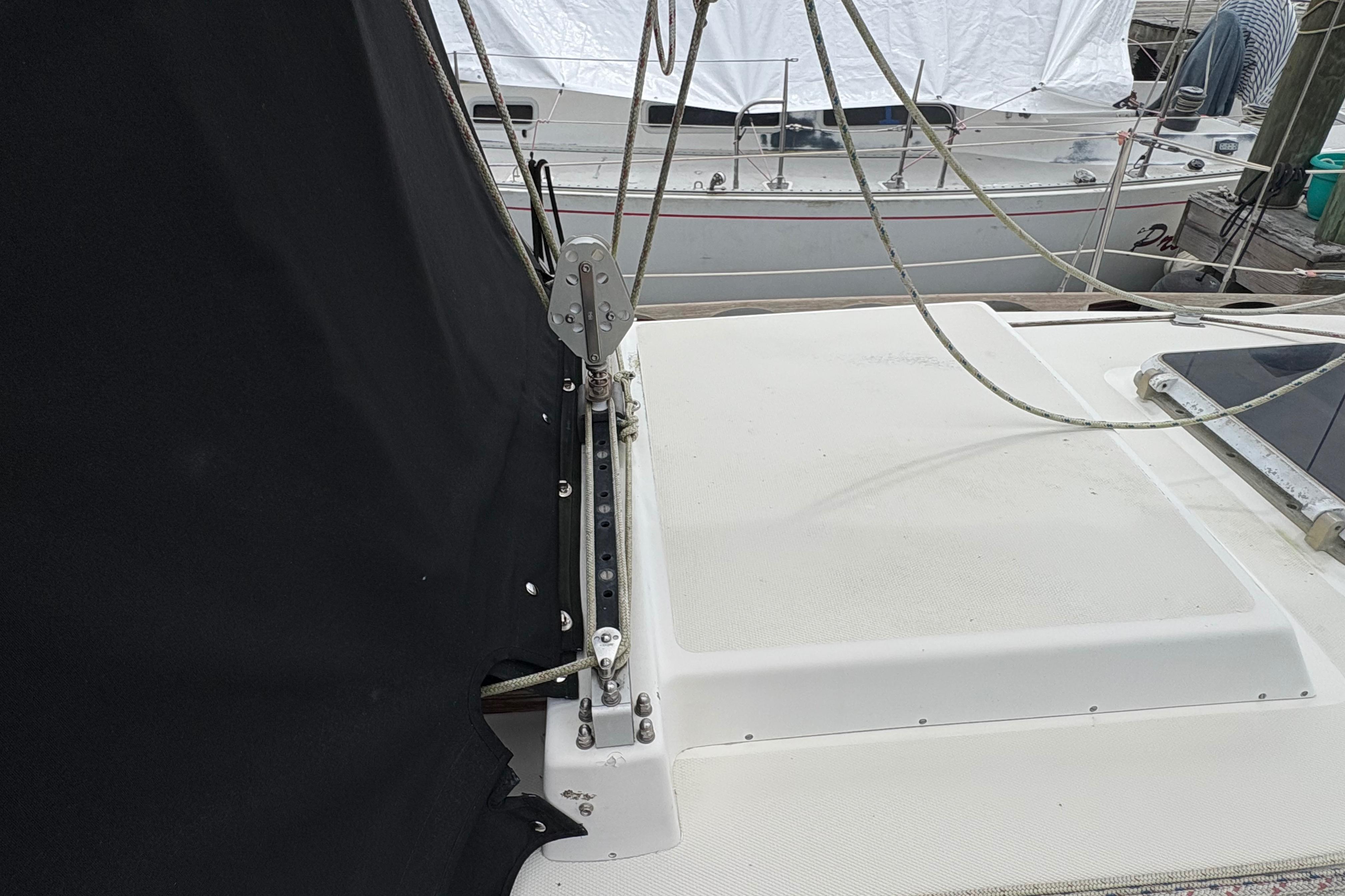 1981 Sabre 31 sailboat deck with rigging and black cover, docked beside another boat.