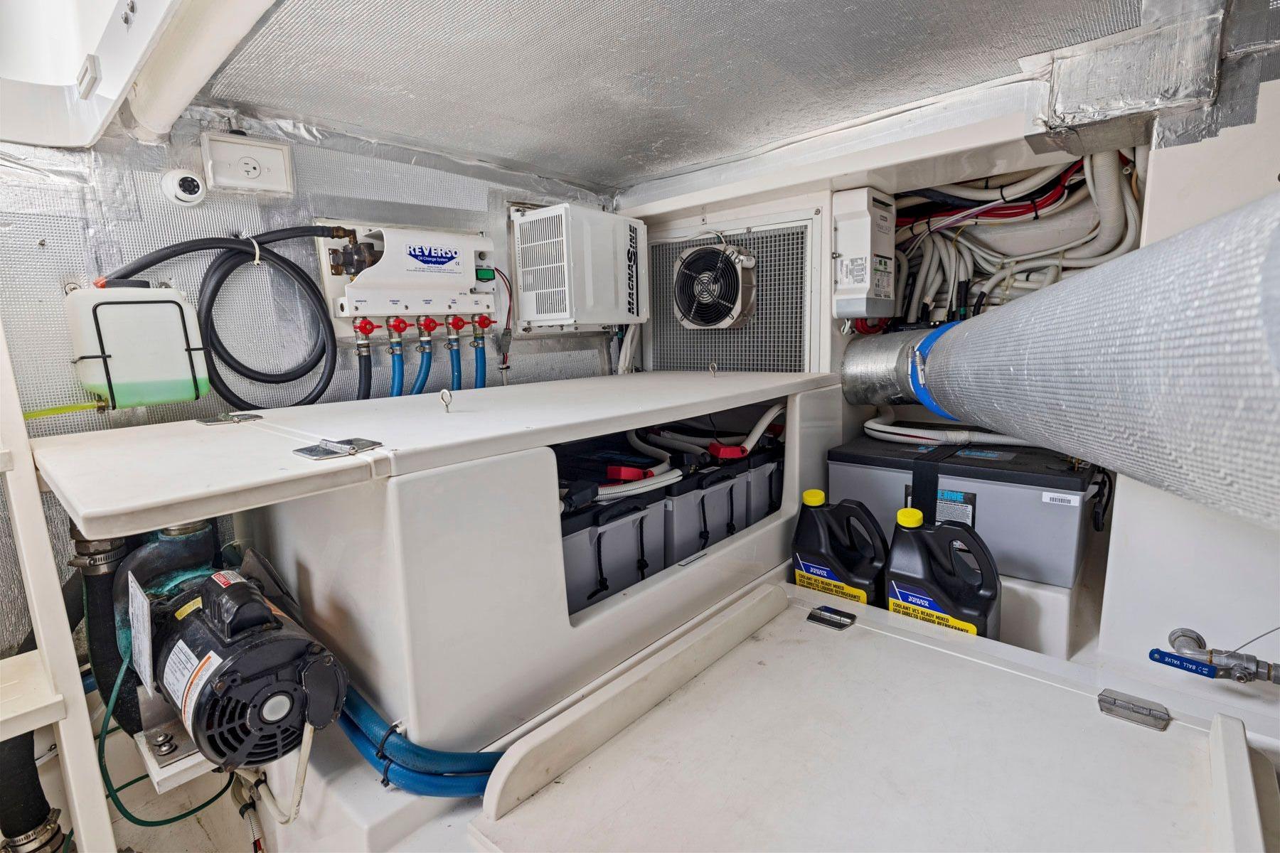 Engine room of 2014 Maritimo M50 yacht, featuring batteries and maintenance equipment.
