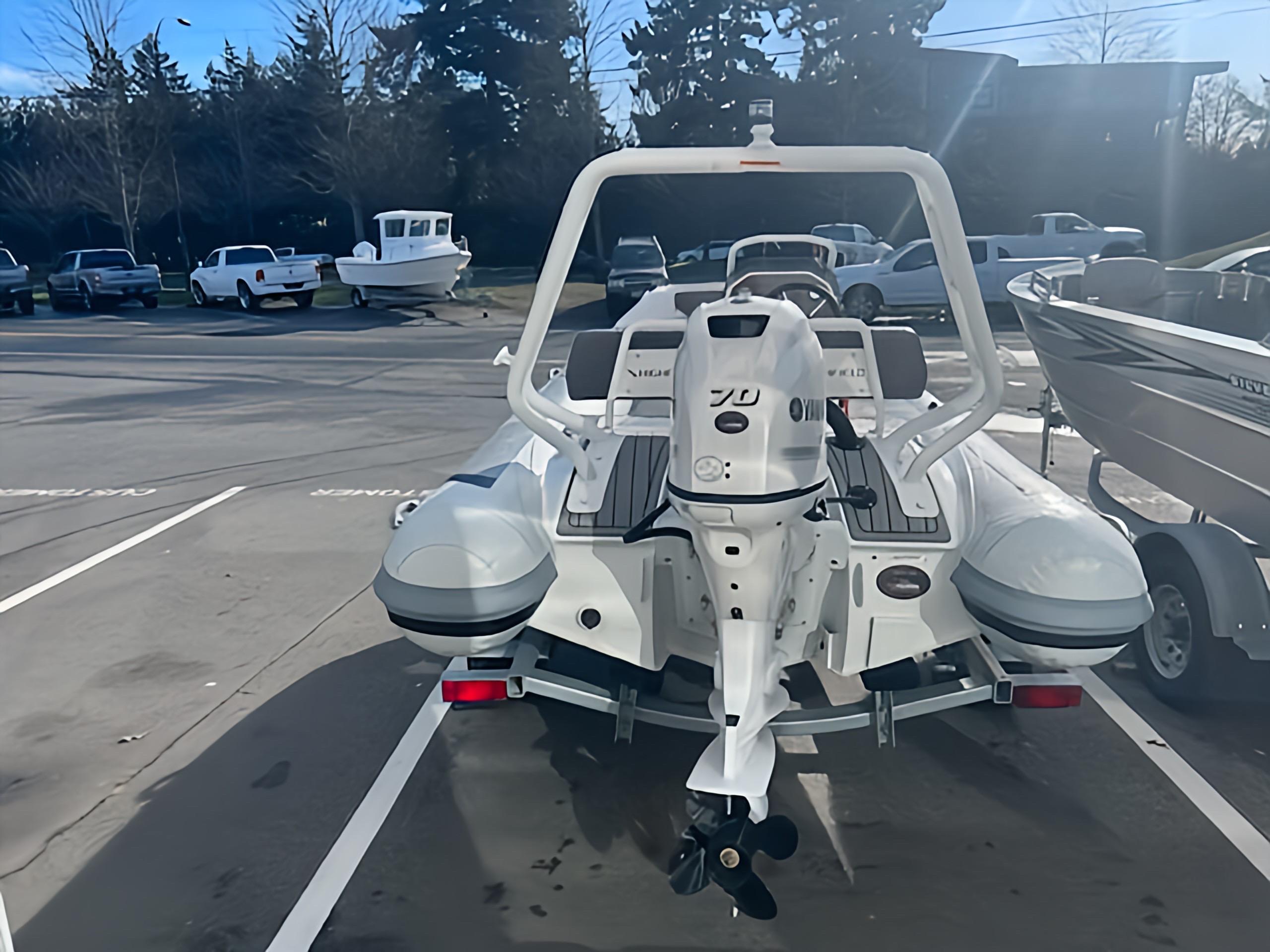 2023 Highfield Sport 420 boat parked in a marina with other vessels.