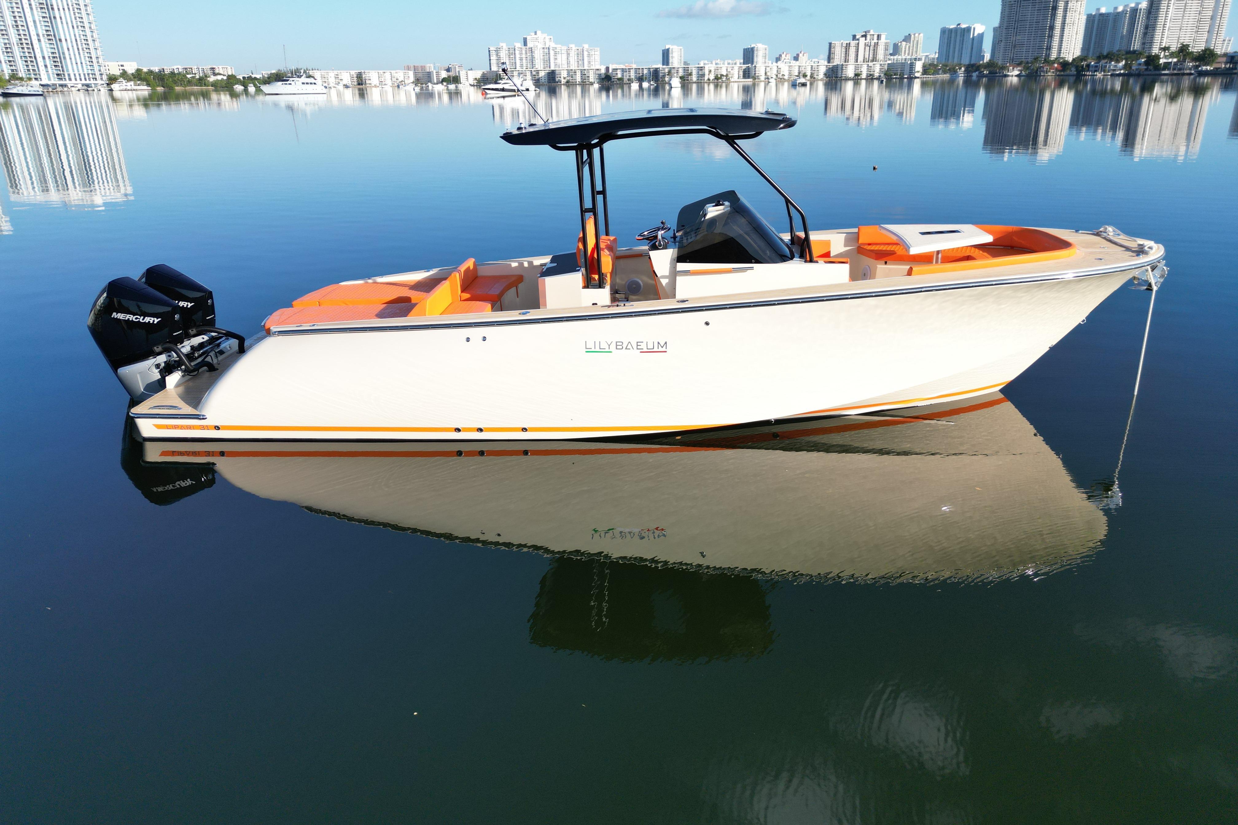 2026 Lilybaeum Lipari 31 boat on calm water with city skyline background.