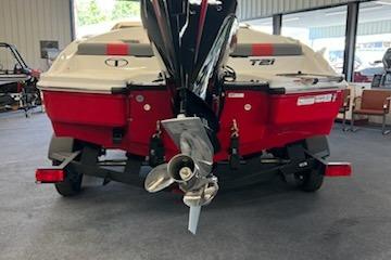 2025 Tahoe T21 boat, rear view, in a showroom with visible propeller.