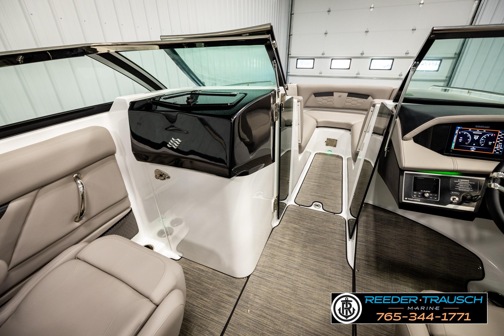 2024 FOURWINNS HD5 Surf boat interior with modern dashboard and seating.
