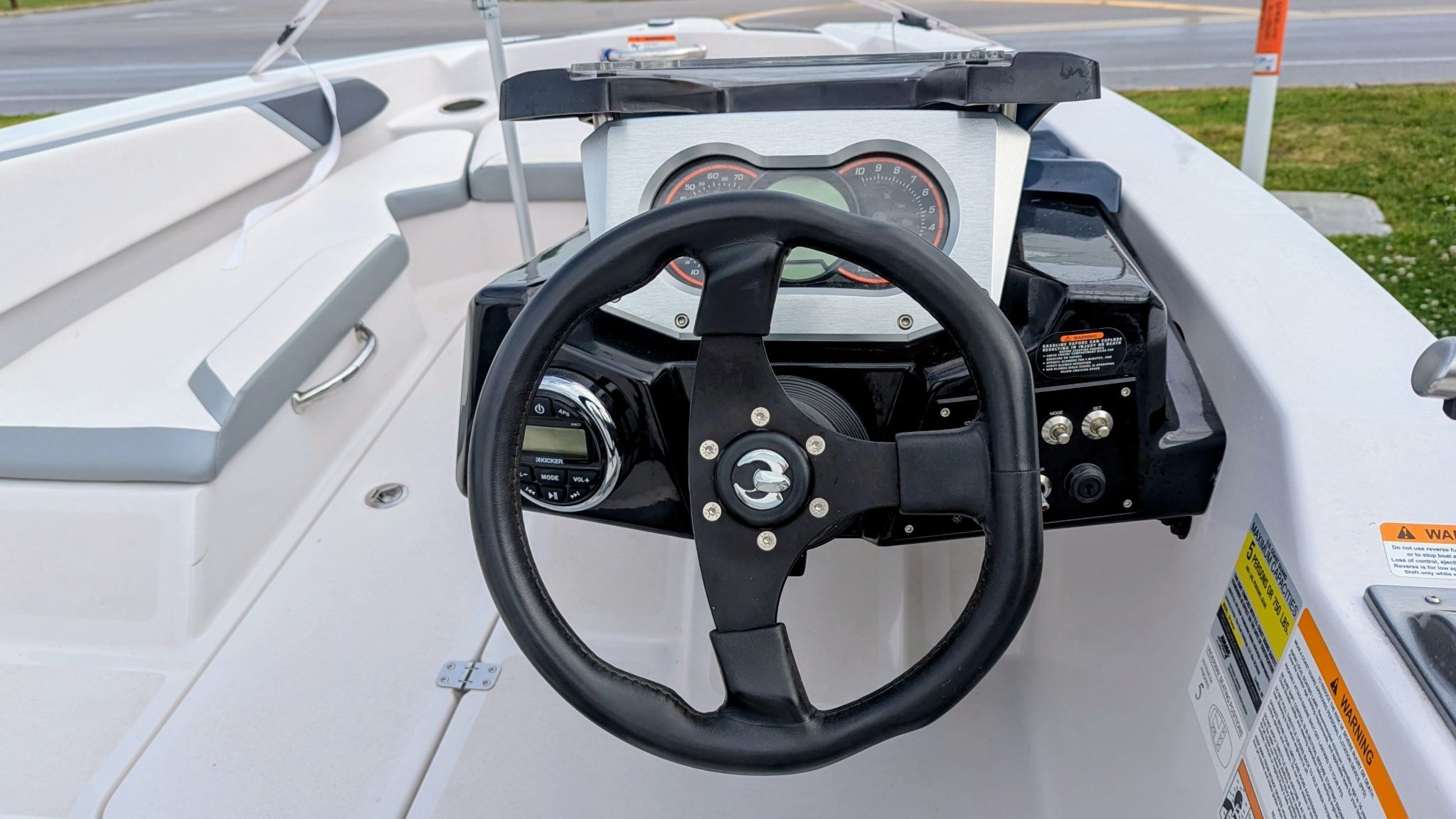 Steering wheel of a 2017 Scarab 165 H.O. boat, close-up view.